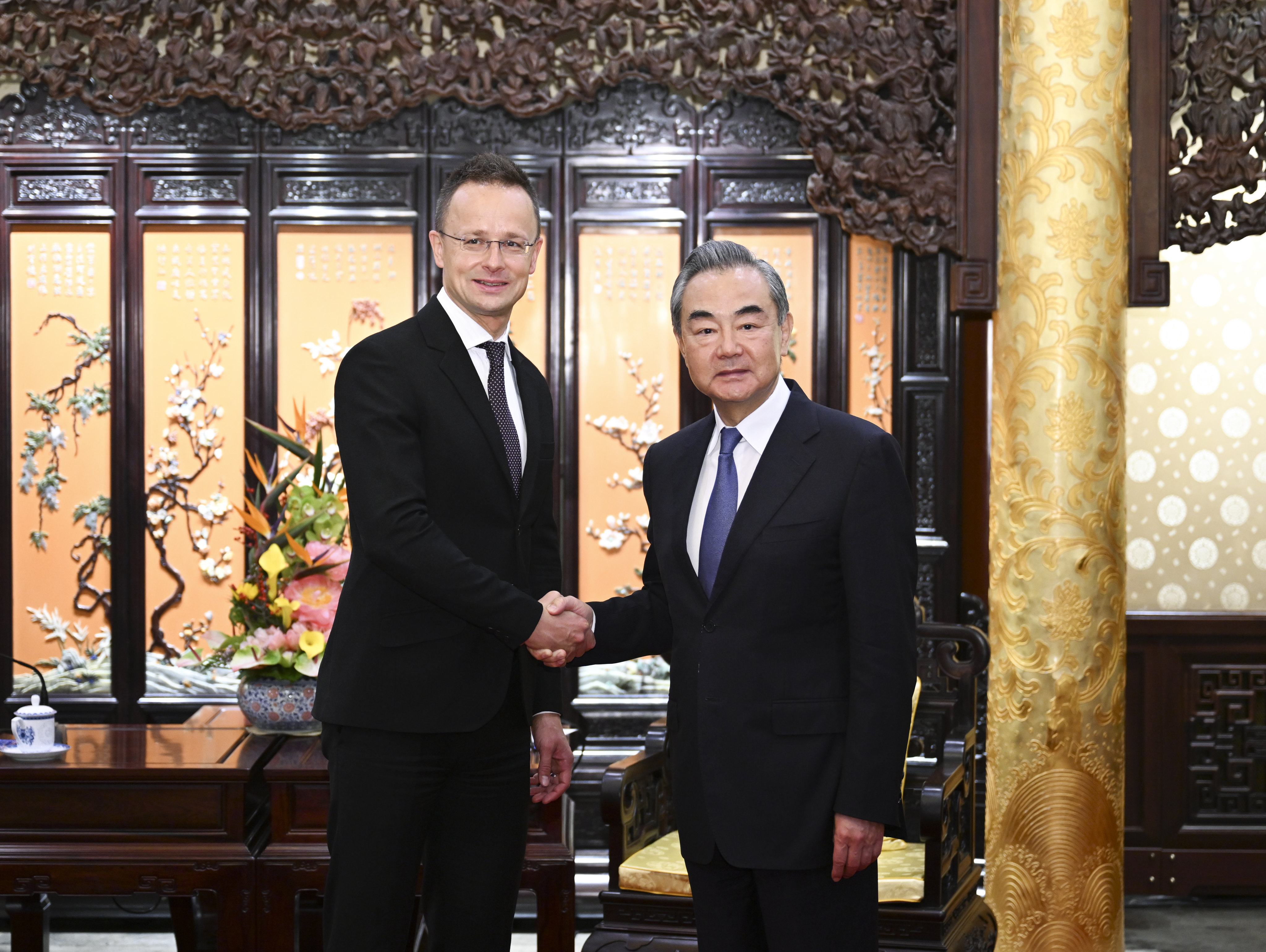 China’s top diplomat Wang Yi (right) shakes hands with Hungarian foreign minister Peter Szijjarto in Beijing on Monday. Photo: Xinhua