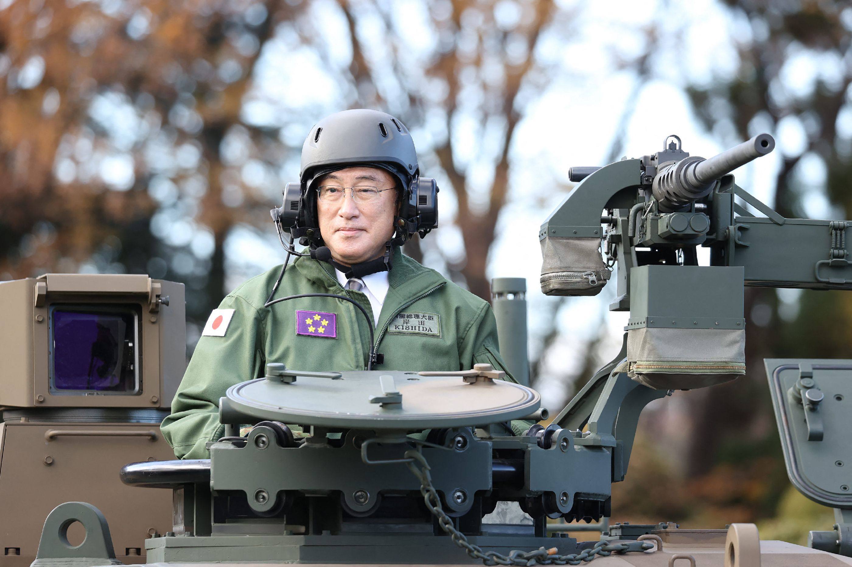 Japanese Prime Minister Fumio Kishida rides atop a tank during a military review at the Japanese Ground Self-Defence Force’s Camp Asaka in Tokyo on November 27, 2021. Kishida has ordered a sharp rise in defence spending to 2 per cent of gross domestic product by 2027. Photo: AFP
