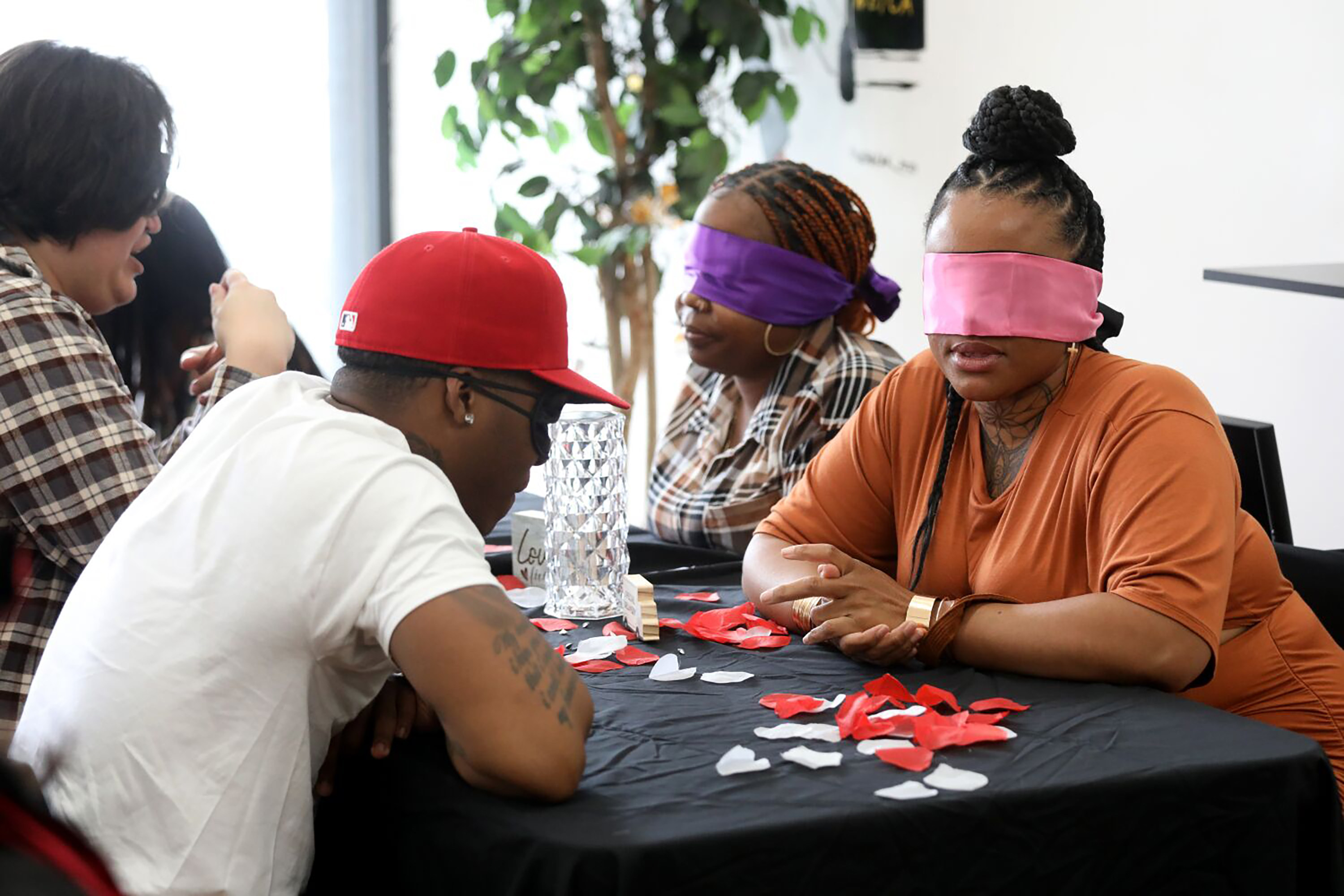 Left to right, Joseph Jessup, of Burbank, music artist Head, of St. Louis, Jessica Holmes, of Compton, and Ashley Franklin, of Anaheim, at a blindfolded speed dating event at the New Millenium Beauty and Barber Shops on Saturday, April 29, 2023, in Los Angeles. Miss Haze began hosting blindfolded speed dating events in her hometown of St. Louis before “Love is Blind” blew up on Netflix. Now, she’s bringing the experience to L.A. for the first time. (Gary Coronado/Los Angeles Times/TNS)