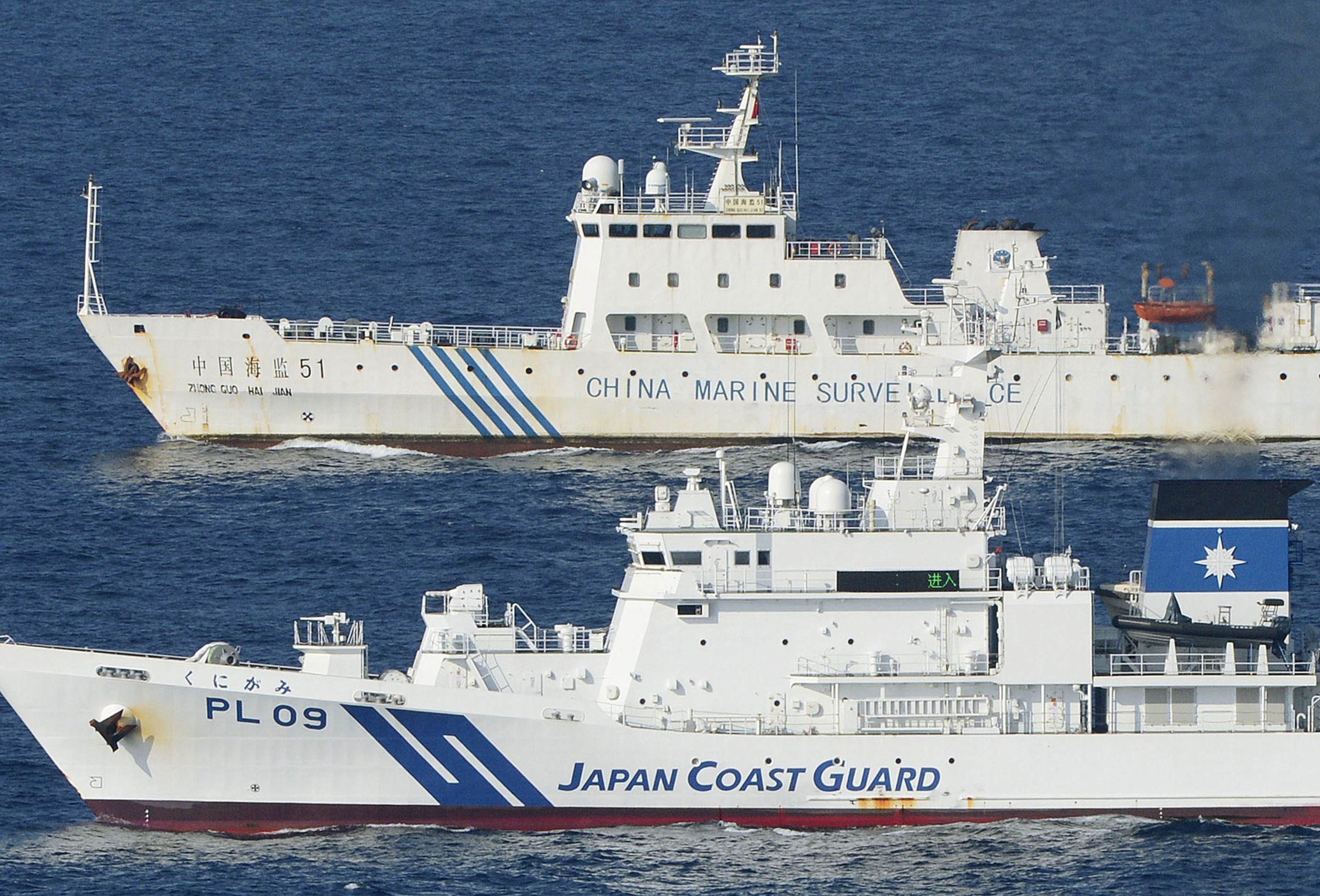 Chinese and Japanese coast guard vessels steam side by side near disputed East China Sea islands called Senkaku in Japan and Diaoyu in China. Photo: AP