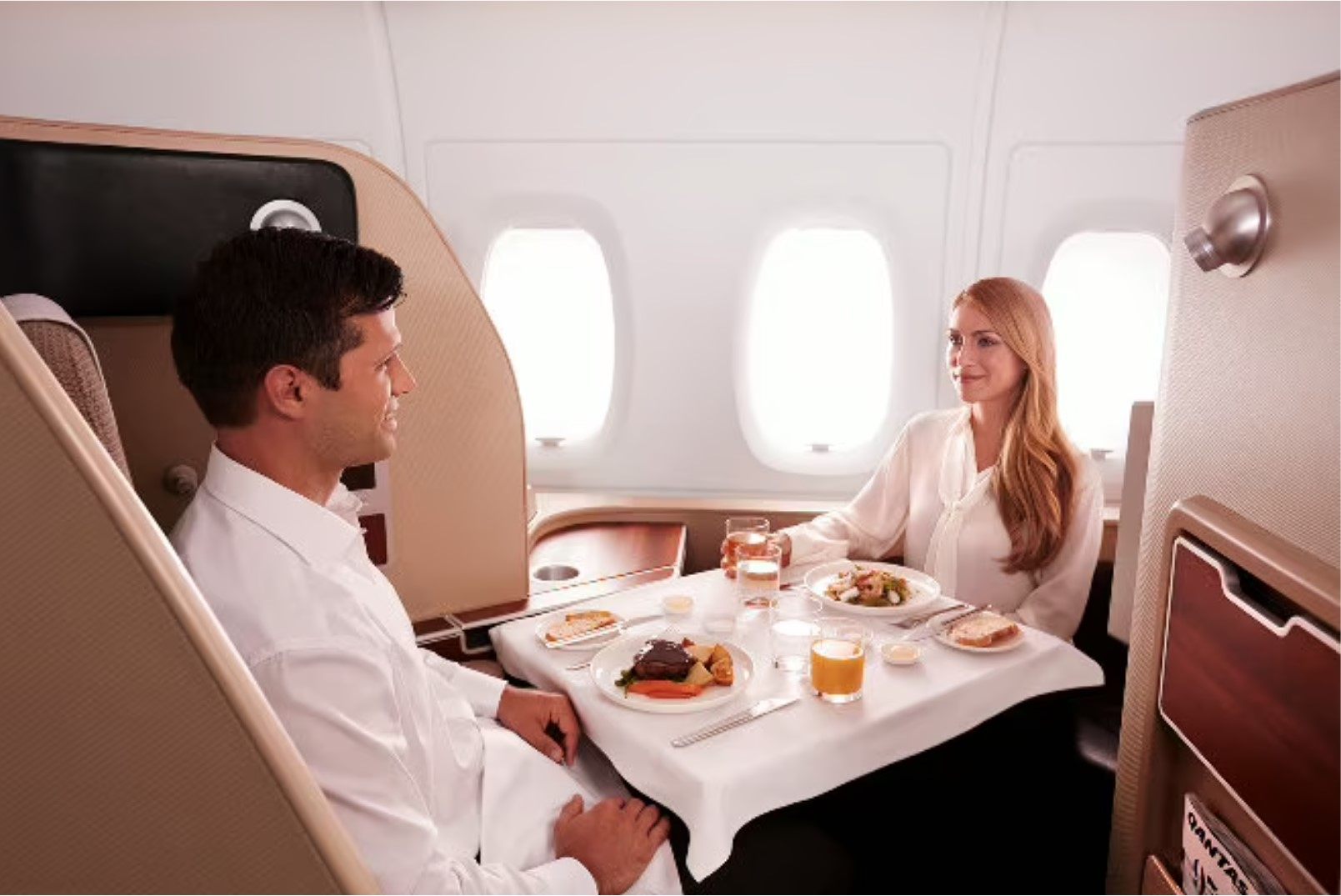 Airlines are showcasing their plush new first classes, with cabins even designed to seat two people in case travellers want to eat together. Photo: Qantas