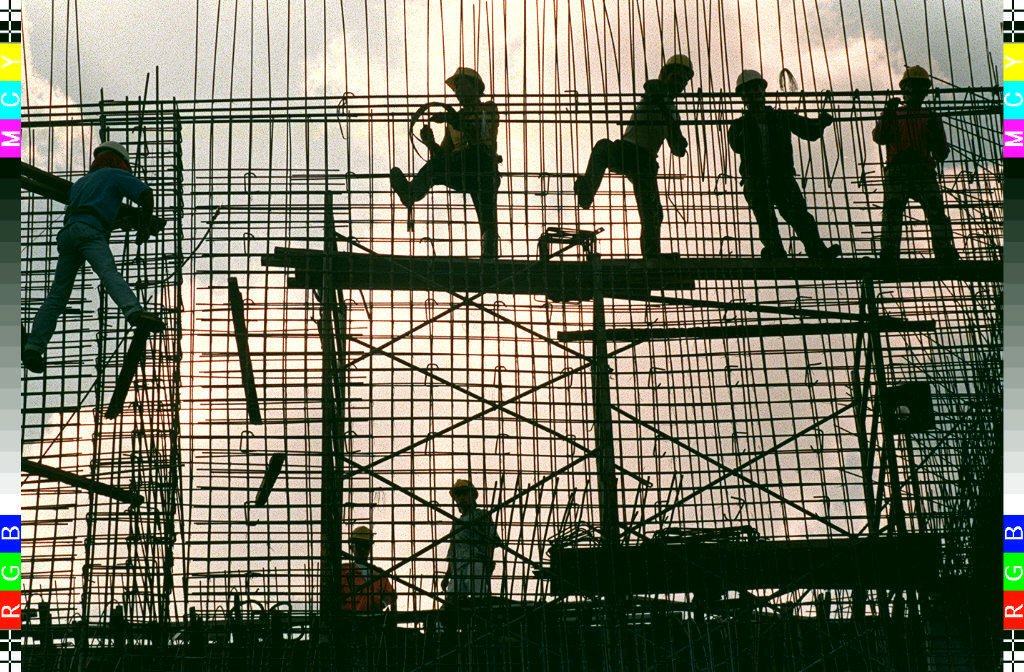 Workers erect a reinforcement grid of iron bars for a concrete wall of a power substation in Manila. Photo: AFP
