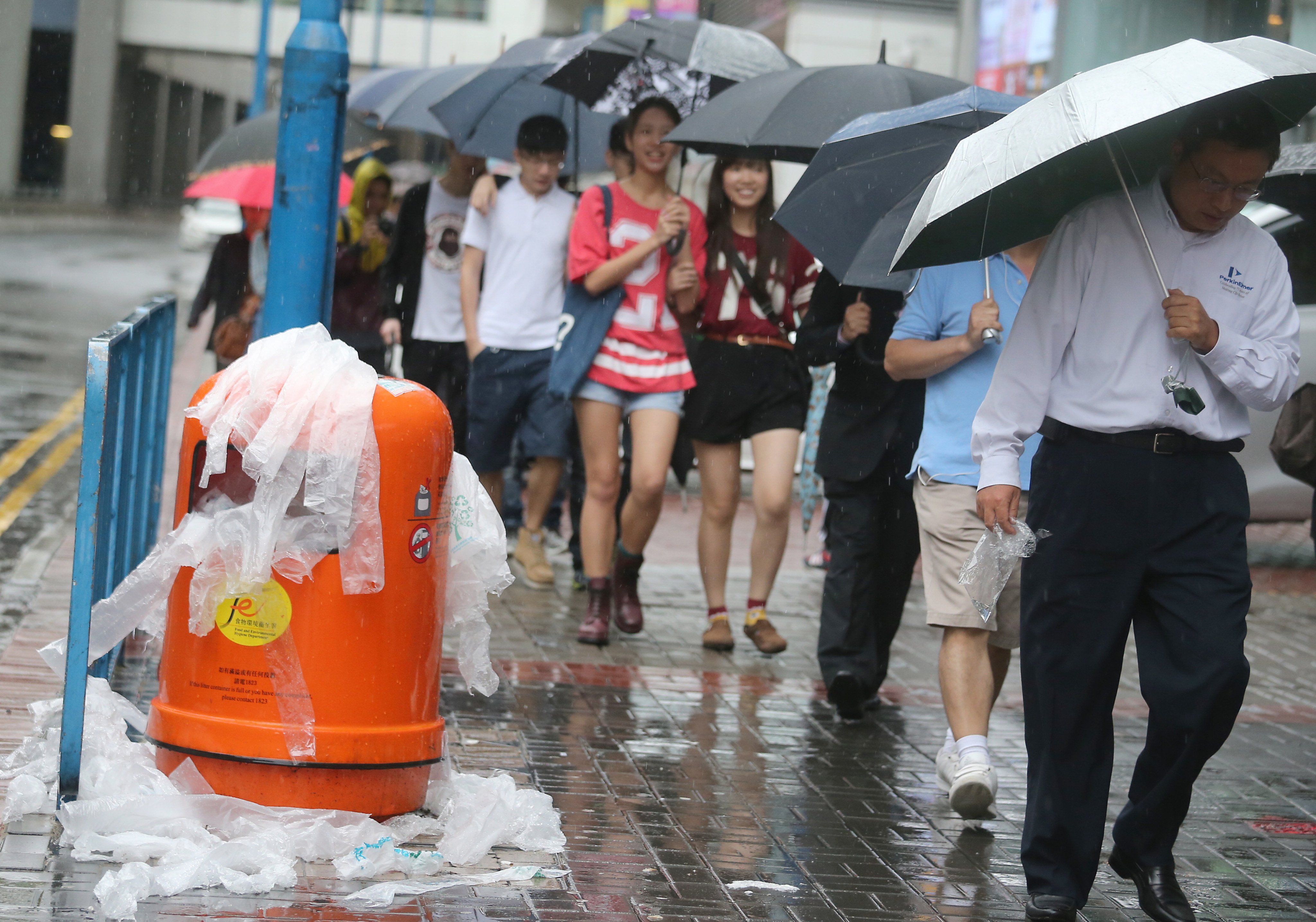 A bin overflows with plastic umbrella bags on a rainy day in Kwun Tong. Two-thirds of plastic is produced for single use. Photo: David Wong

