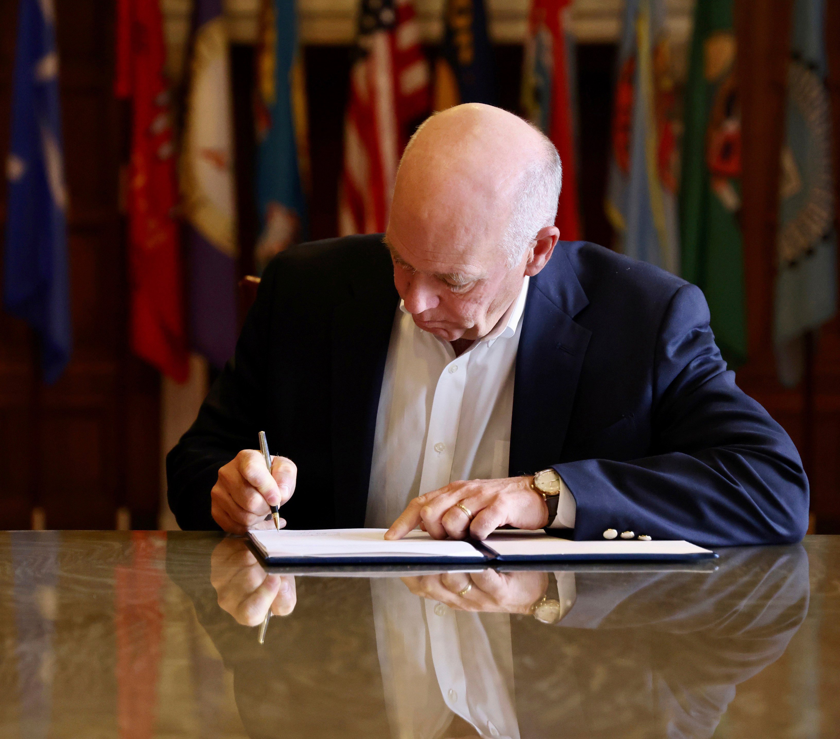 Greg Gianforte, the state’s Republican governor, signs the measure into law in Helena, Montana, on Wednesday. Photo: Montana Governor’s Office via AP