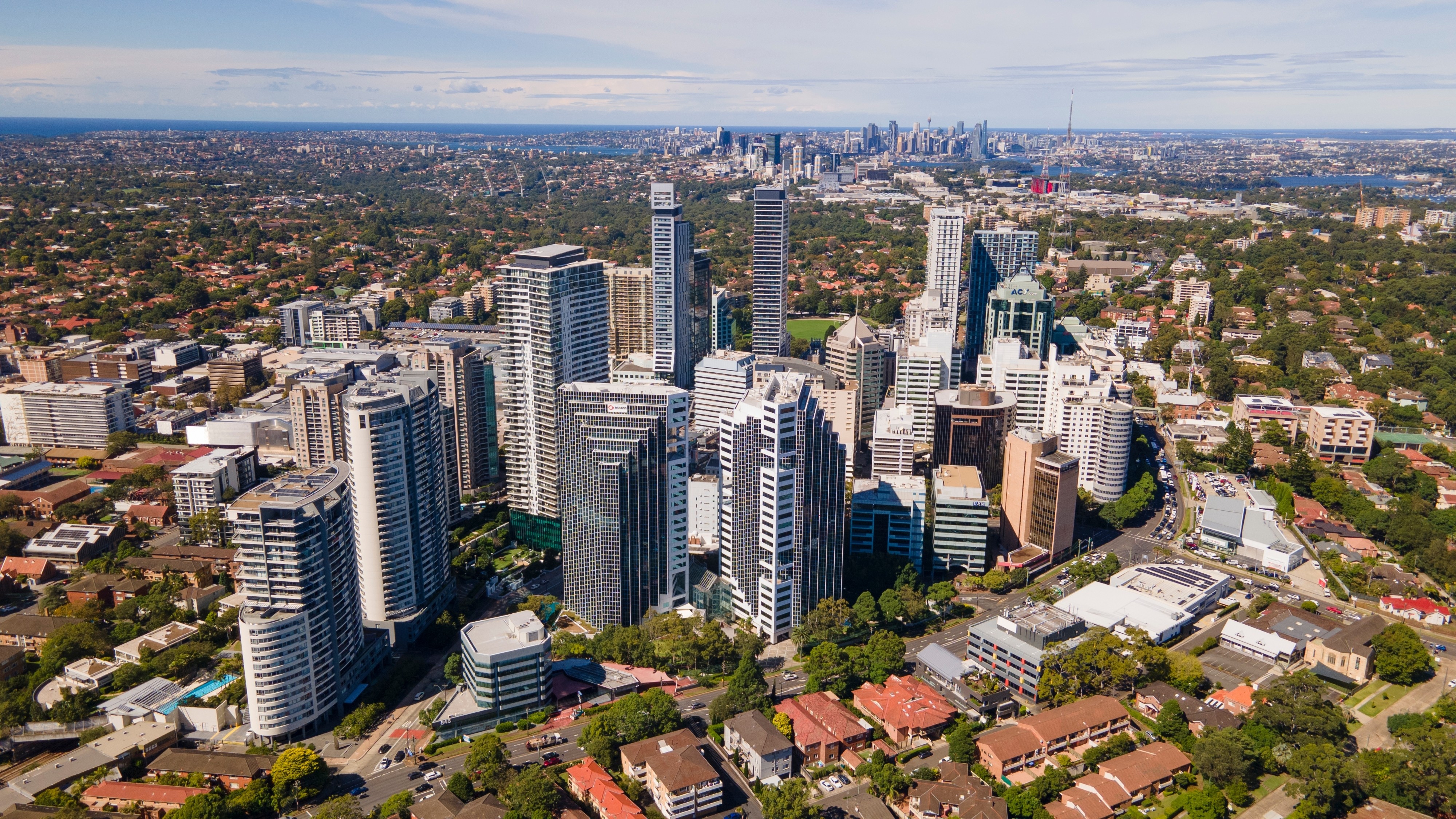 A drone’s eye view of the business district of Chatswood a north shore satellite city of Sydney, visible in the distance. Photo: Shutterstock