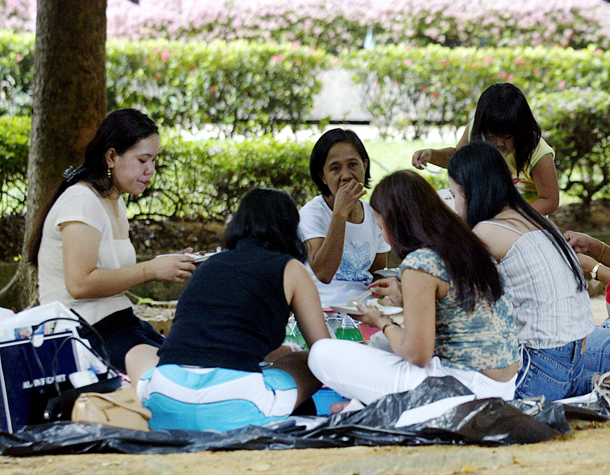 Foreign domestic workers enjoy a picnic in Singapore. Many Asian women are driven by poverty to seek work abroad as domestic helpers. A lot of them end up in Singapore or Hong Kong. South Korea could soon be another hotspot. File photo: AFP