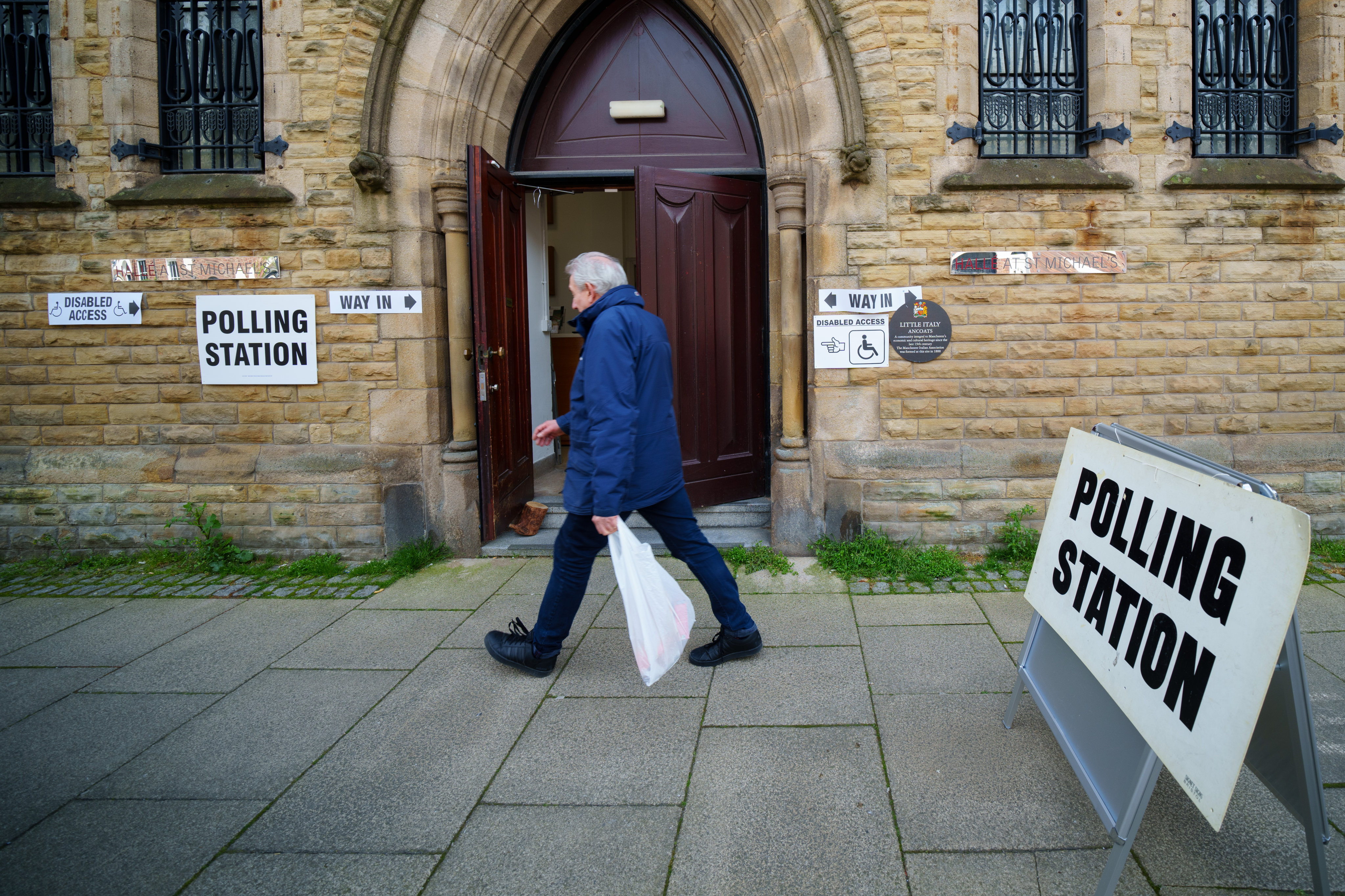 A man walks past a polling station for local elections in Manchester, northern England, on May 4. Britain’s ruling Conservative party lost over 1,000 seats in elections across England. Photo: Xinhua