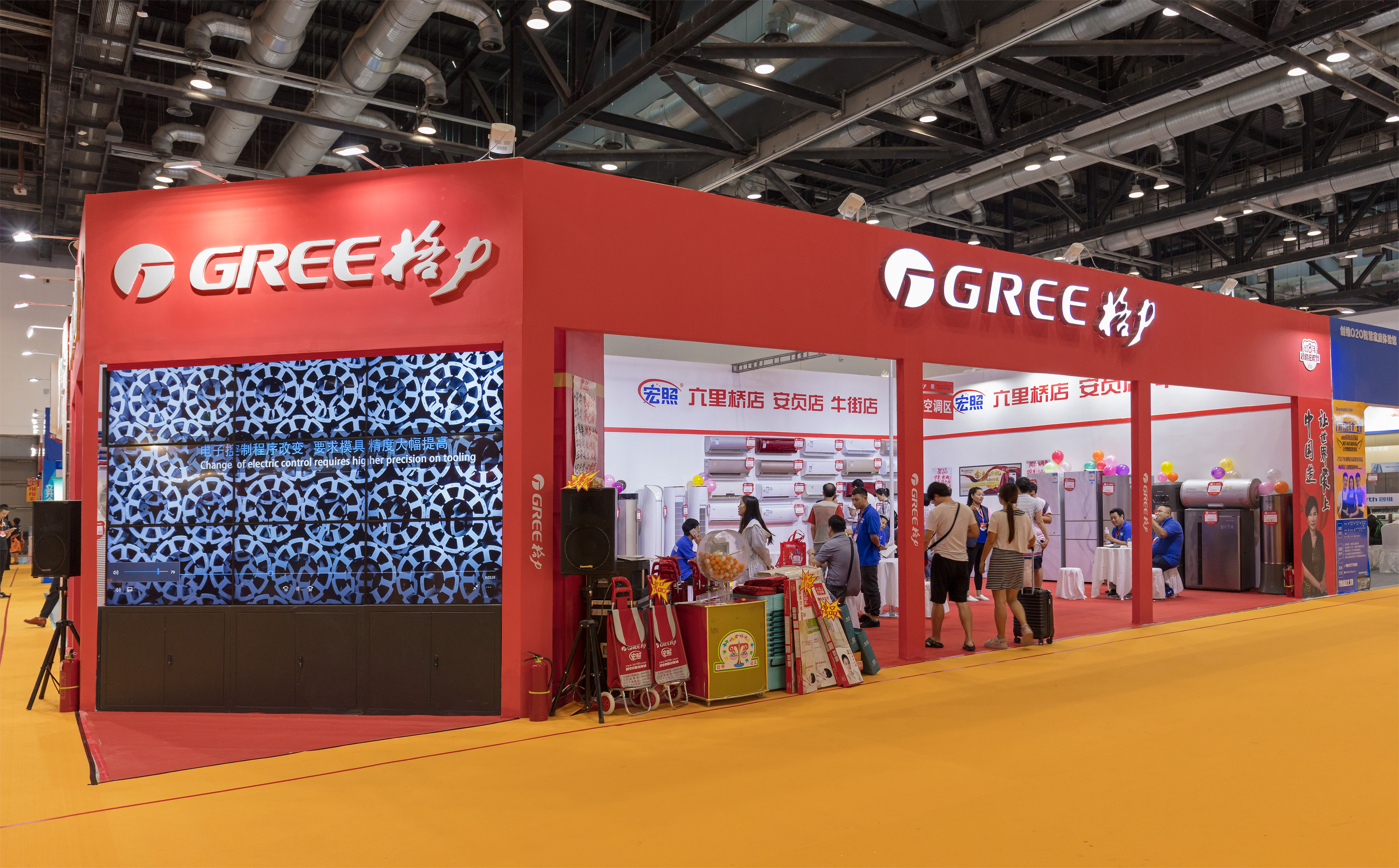 Visitors are seen at the Gree Electric booth during the China Hua Xia Housing and Furnishing Exposition. Photo: Shutterstock Images