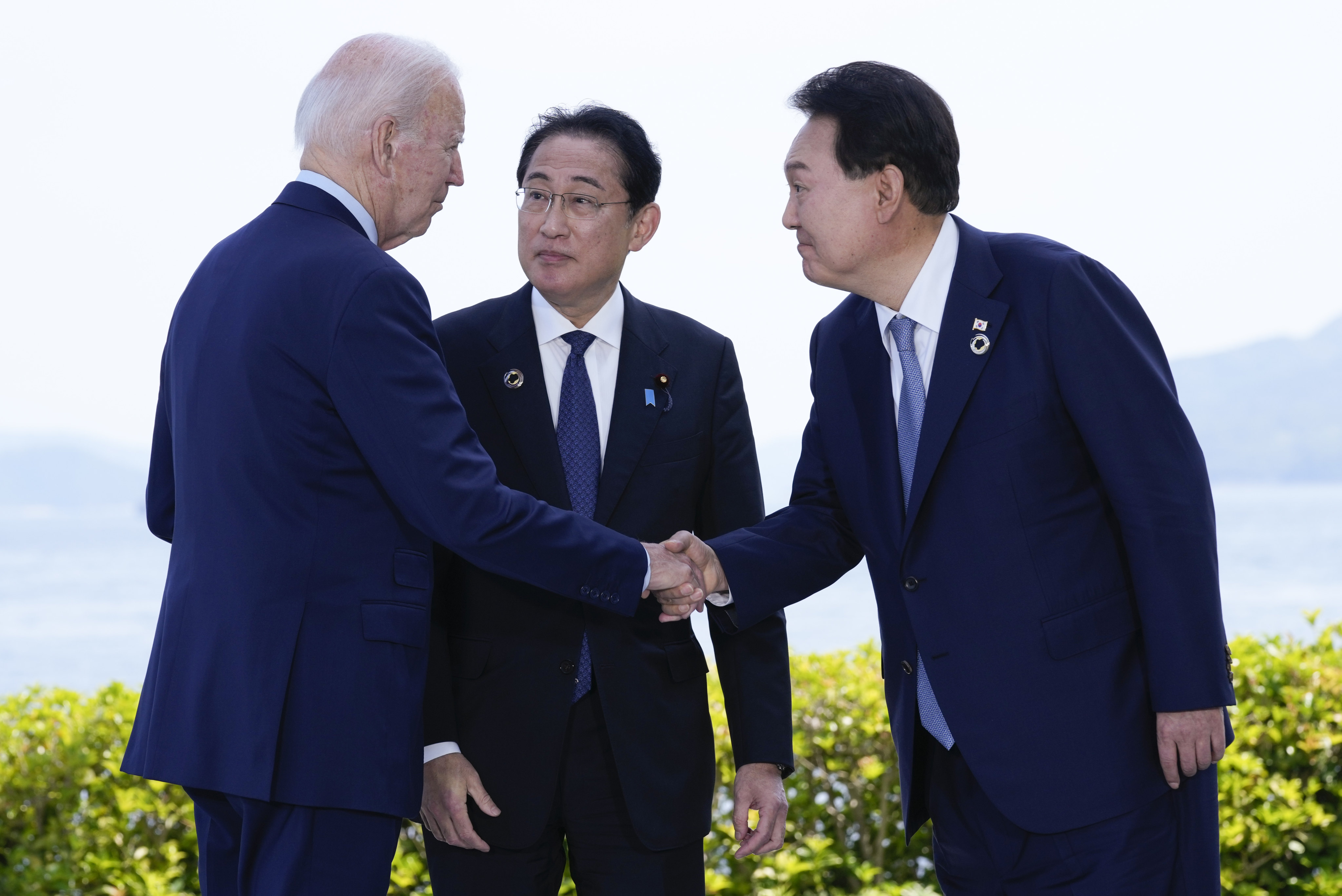 US President Joe Biden shakes hands with South Korean President Yoon Suk-yeol as Japanese Prime Minister Fumio Kishida watches, ahead of a trilateral meeting on the sidelines of the G7 summit in Hiroshima on May 21. The summit has focused on Ukraine, as well as China. Photo: AP 