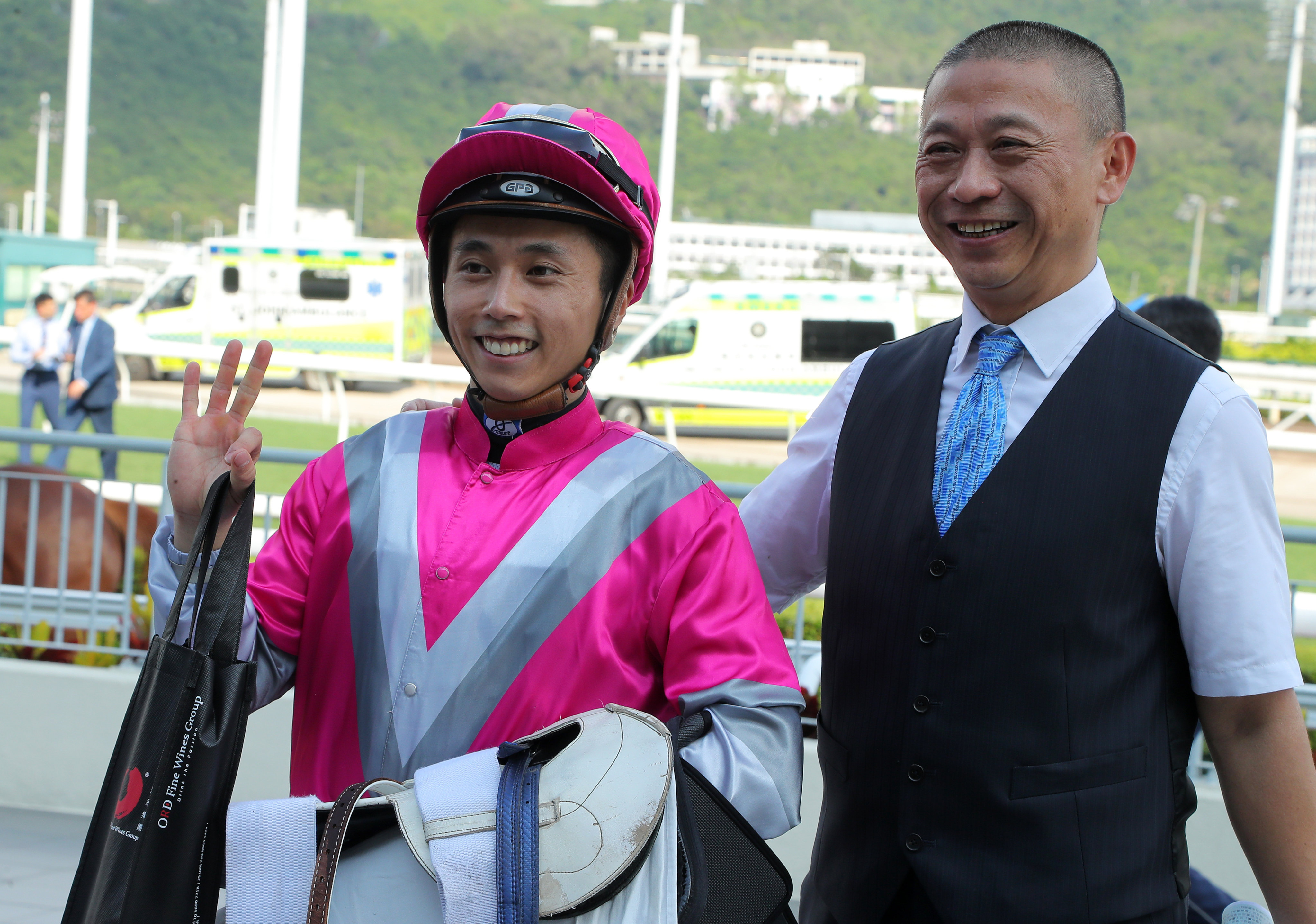 Matthew Poon celebrates completing his Sha Tin treble on Sunday with Ka Ying Spirit’s trainer, Danny Shum. Photo: Kenneth Chan