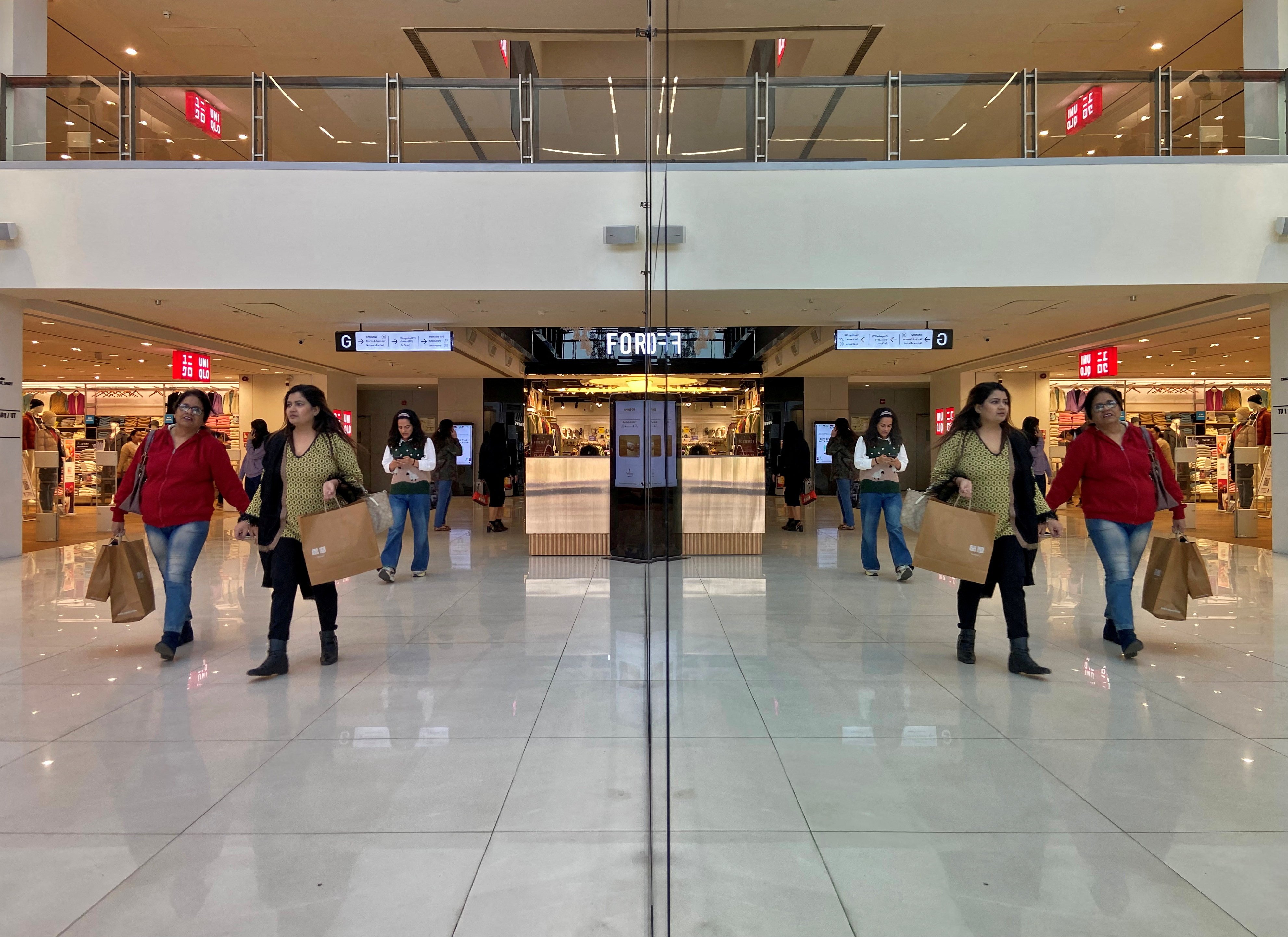 Shoppers are reflected in mirror inside a shopping centre in New Delhi on December 14, 2022. India’s commercial property sector, and its real estate market as a whole, is defying property trends seen elsewhere around the globe. Photo: Reuters