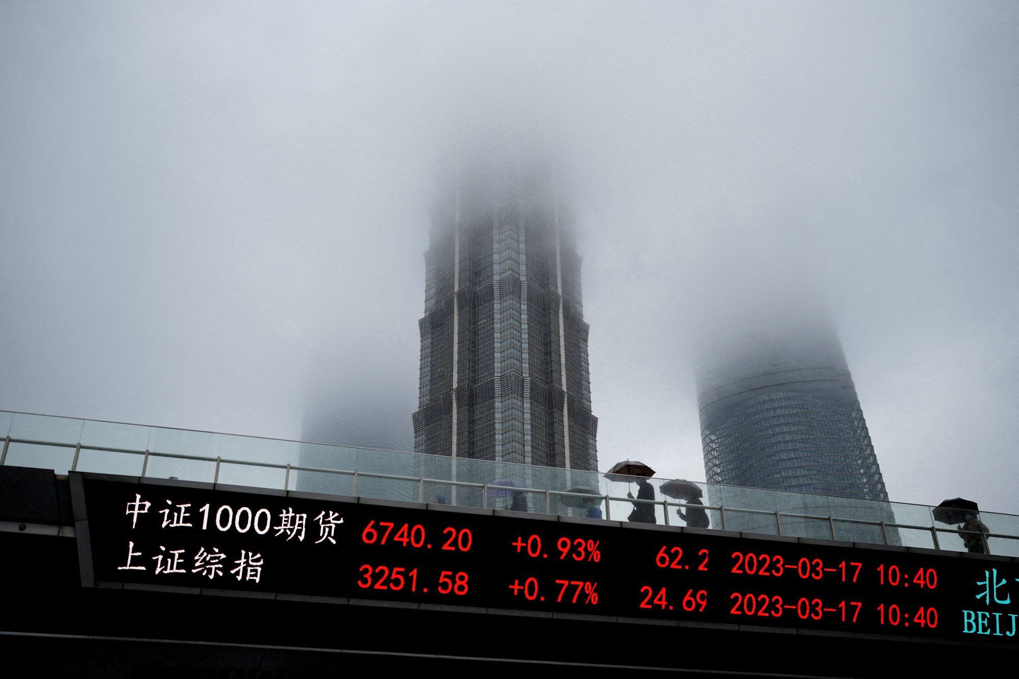 An electronic board shows stock indices at the Lujiazui financial district in Shanghai on March 17, 2023. Photo: Reuters