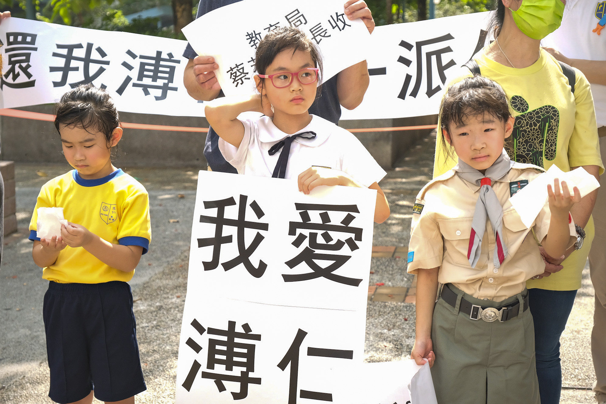 A group of parents and children petition education secretary Christine Choi in a bid to save their primary school. Photo: Handout
