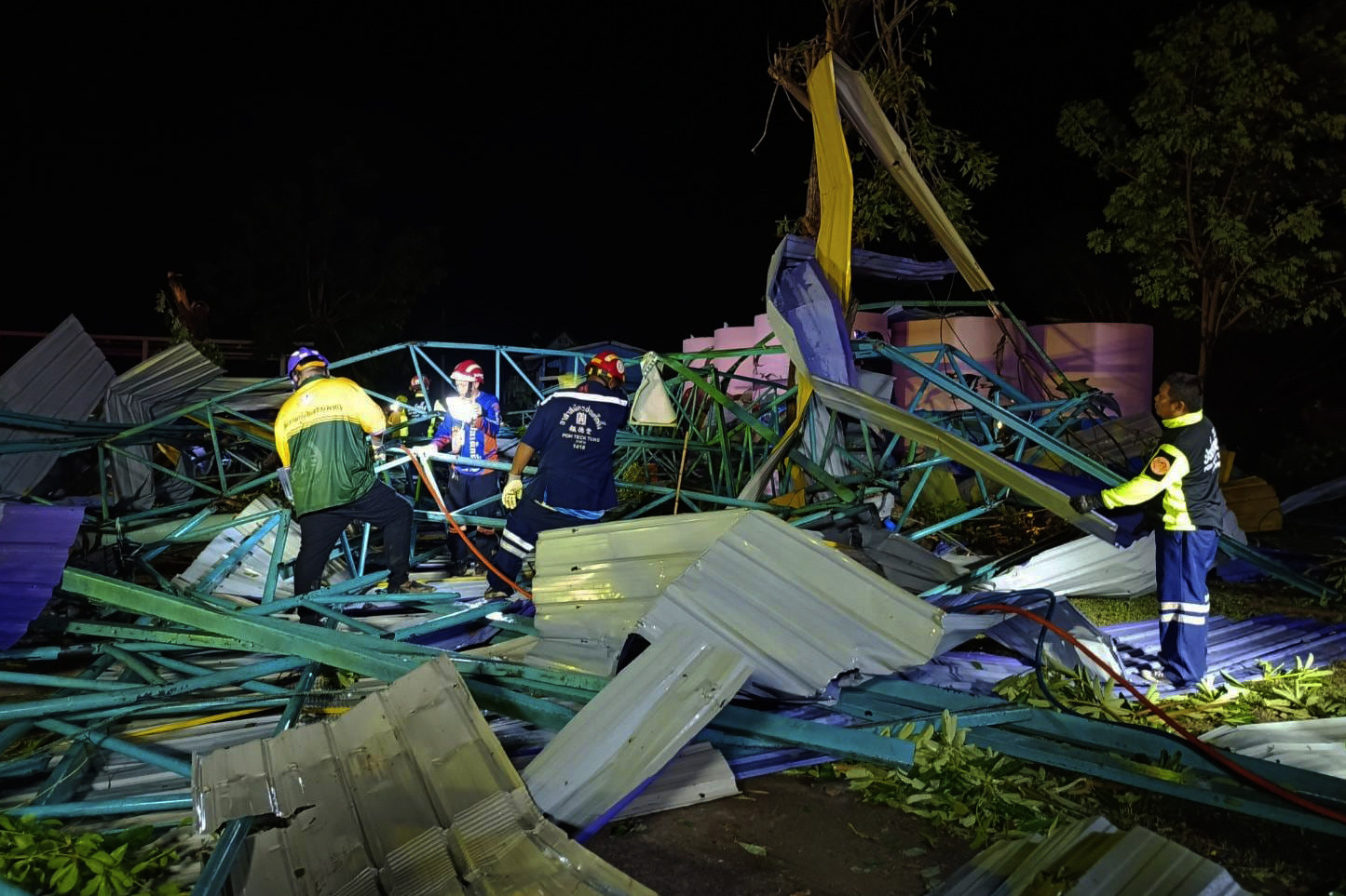 Thai rescue workers at the scene of a collapsed metal roof on a structure at the Wat Nern Por primary school in Phichit province in northern Thailand. Photo: via AP