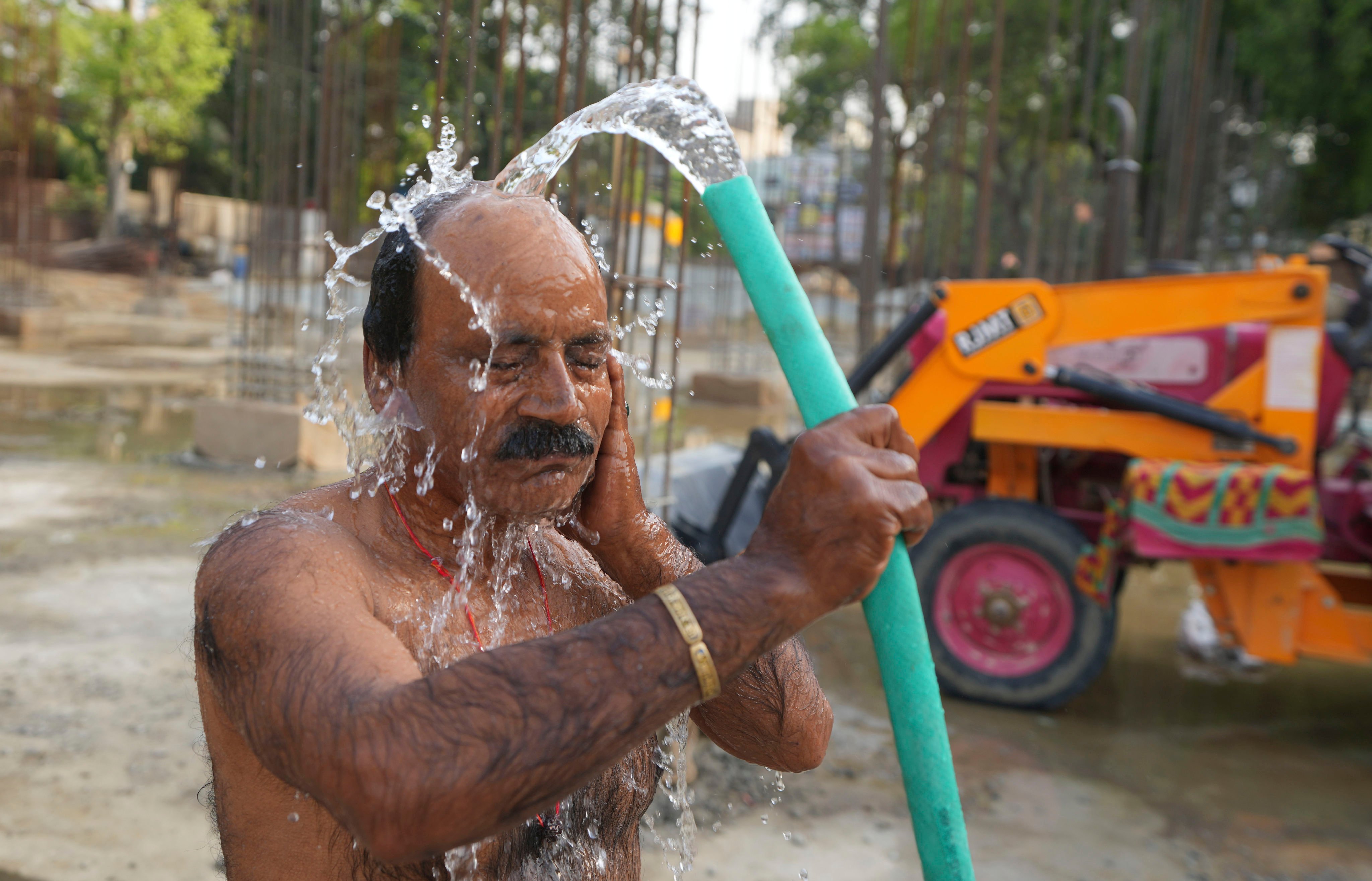 An Indian worker tries to cool off on a hot day in Prayagraj, northern Uttar Pradesh state. Photo: AP
