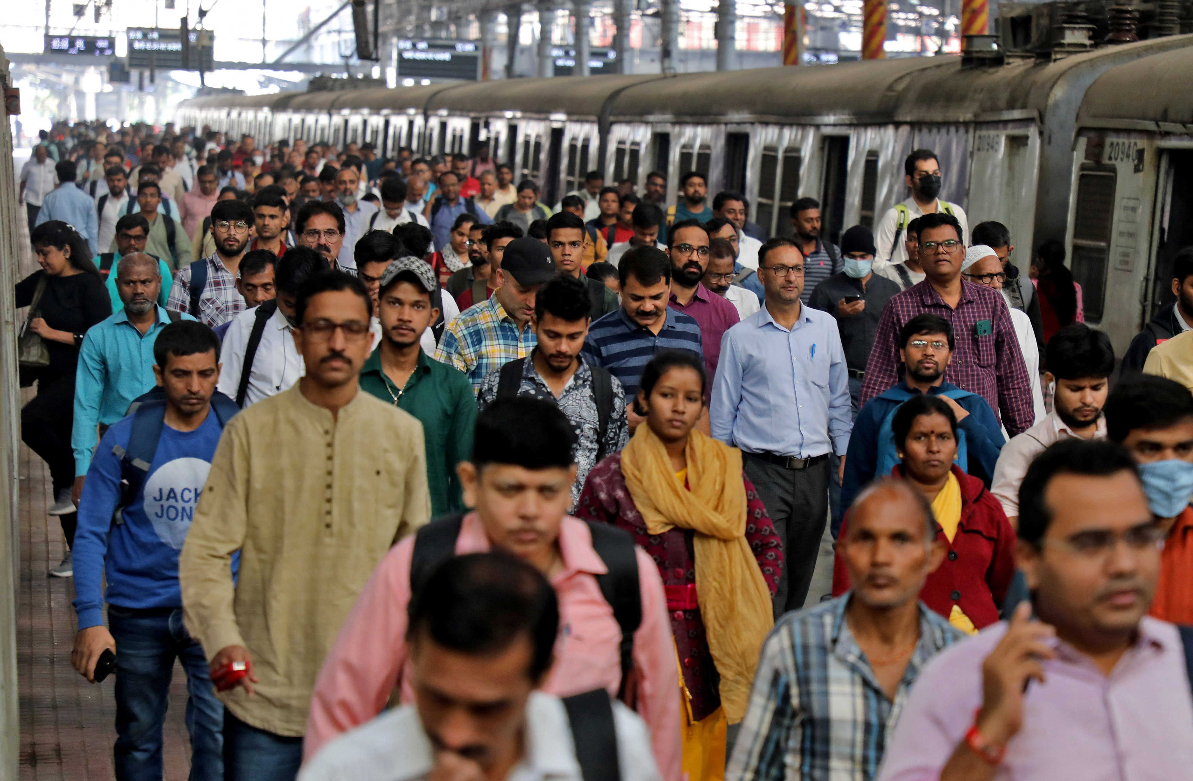 Commuters walk on a platform after disembarking from a train in Mumbai, India. The nation’s last census was due in 2021. It is still unclear when it might happen. Photo: Reuters 
