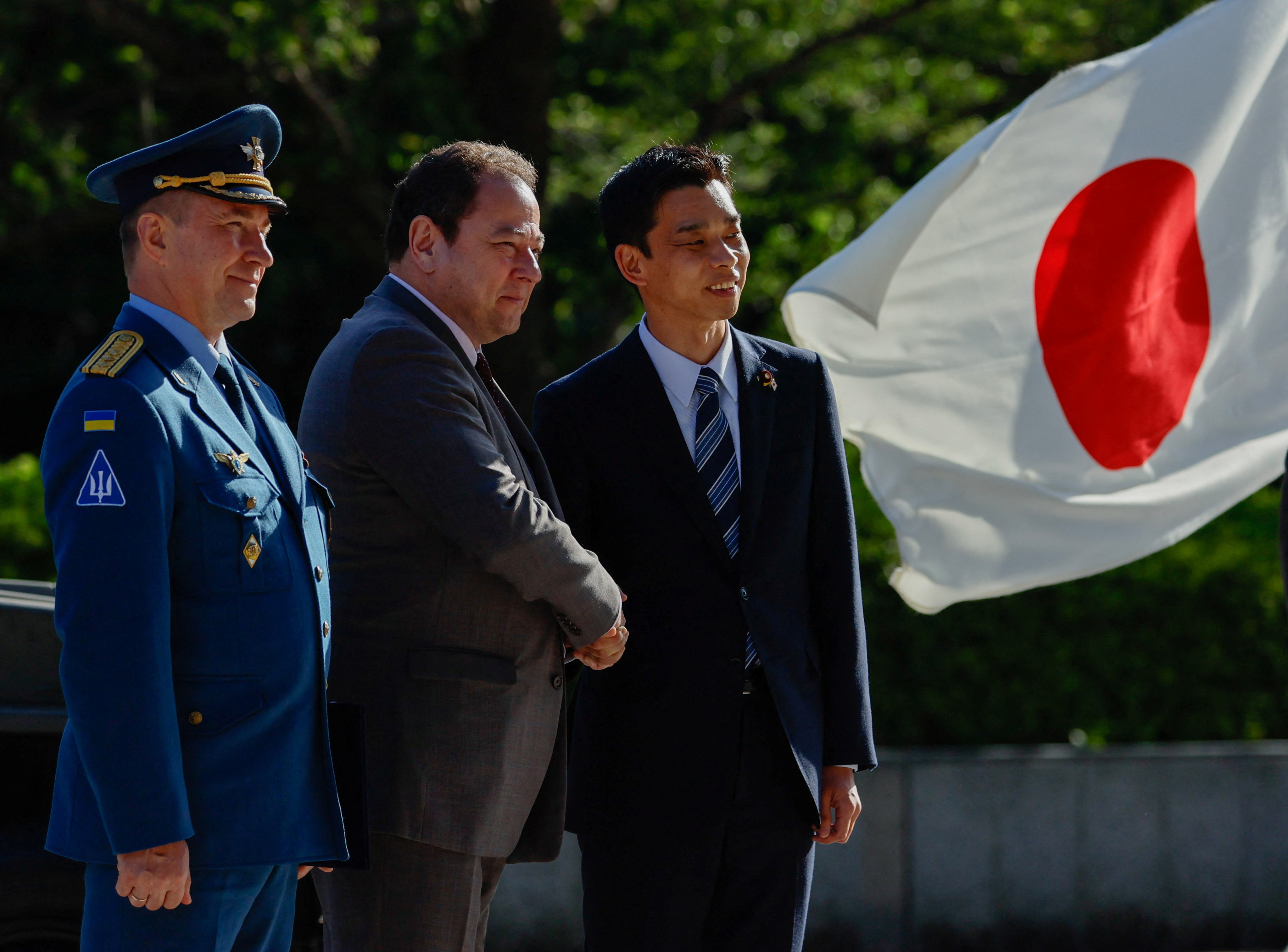 Ukraine’s ambassador to Japan Sergiy Korsunsky and Japan’s State Minister of Defence Toshiro Ino attend a handover ceremony of Japanese Self-Defence Force’s vehicles to Ukraine. Photo: Reuters
