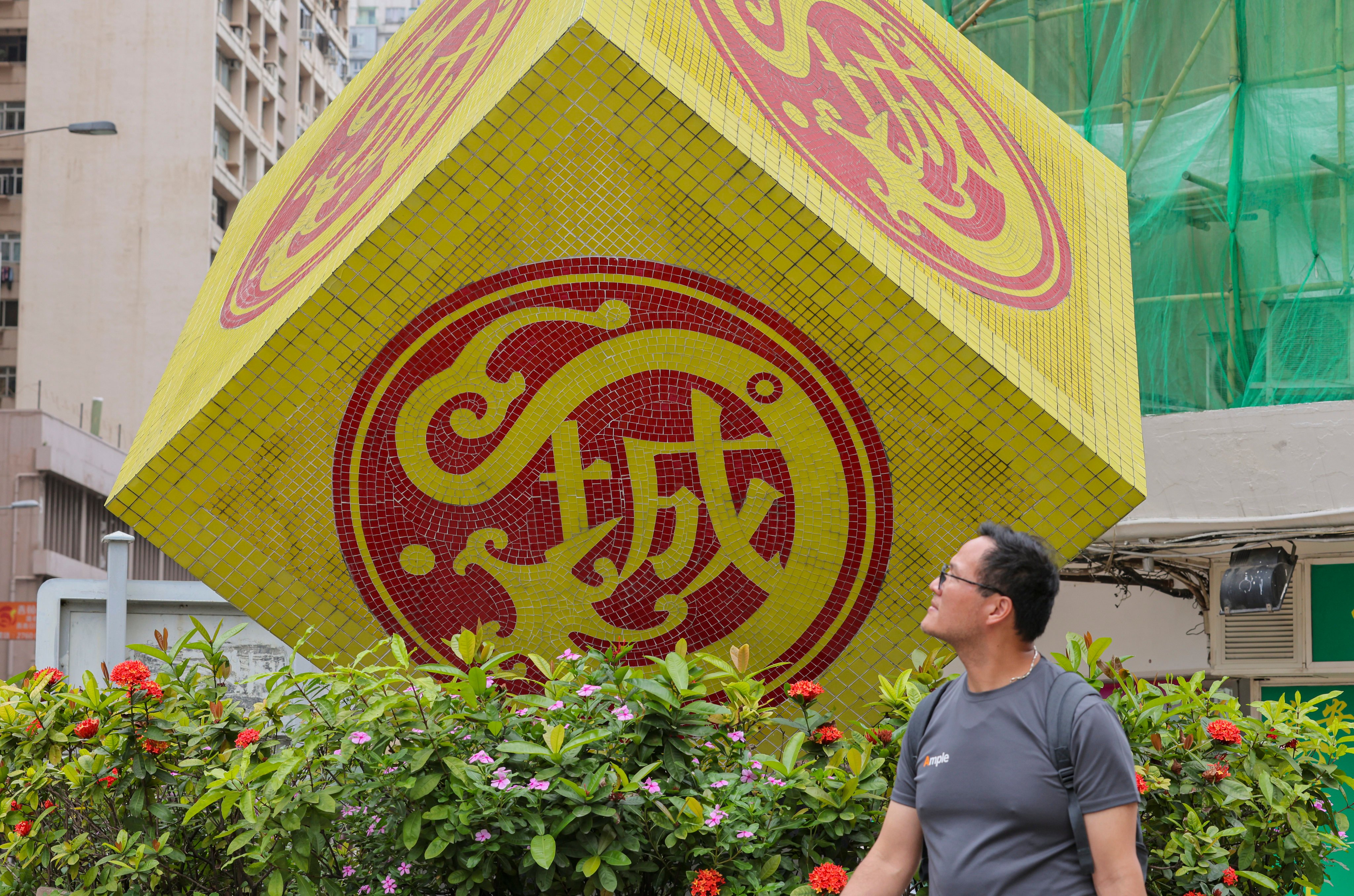 A man walks past the Kowloon City District Council logo on May 2. It is important for district councillors to be well versed in the economy of their district. Photo: Jelly Tse