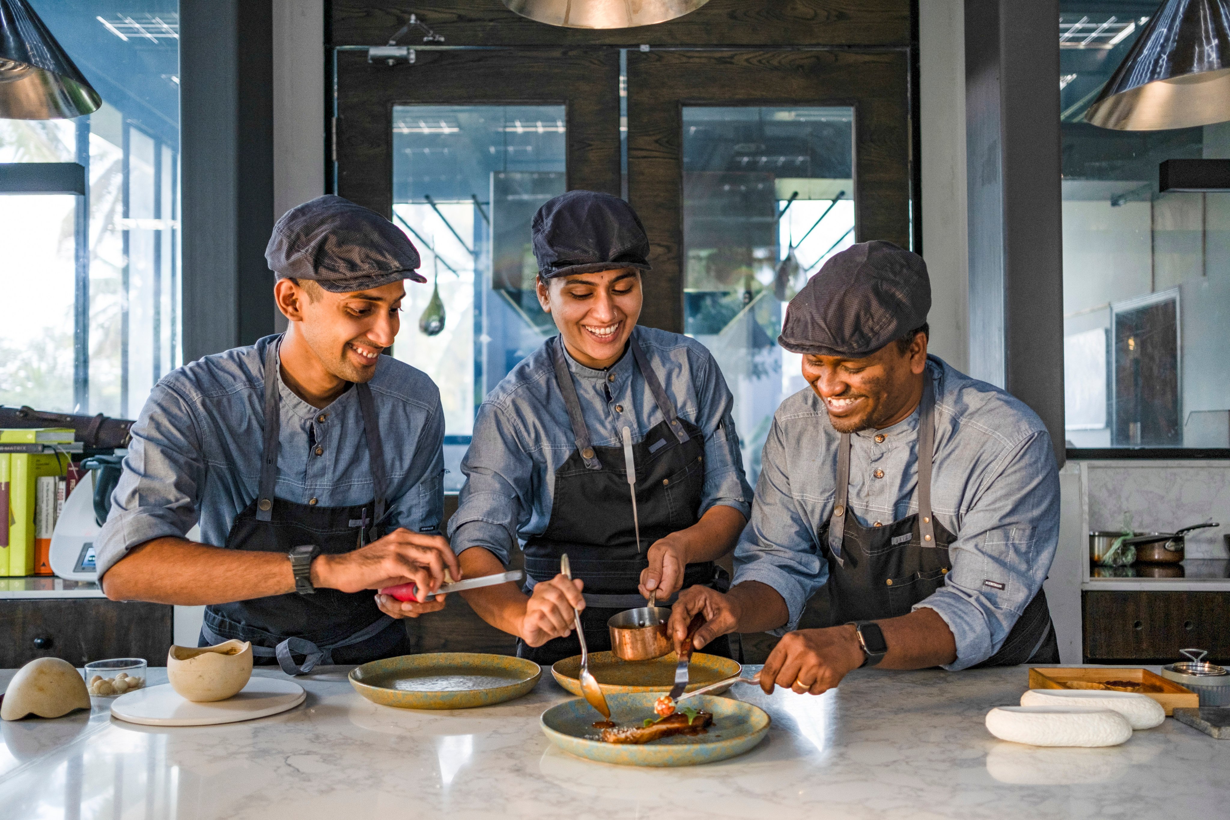 The three chefs of Farmlore - Avinash Vishaal, Mythrayie Iyer and Johnson Ebenezer -are passionate about authentic food.  In Bengaluru, India’s tech hub in the South, the latest entrant on the thriving food scene is Farmlore, an 18-cover restaurant nestled in a mango grove on a 37 acre natural farm in the heart of the city.&#xA;&#xA;Credit: Farmlore