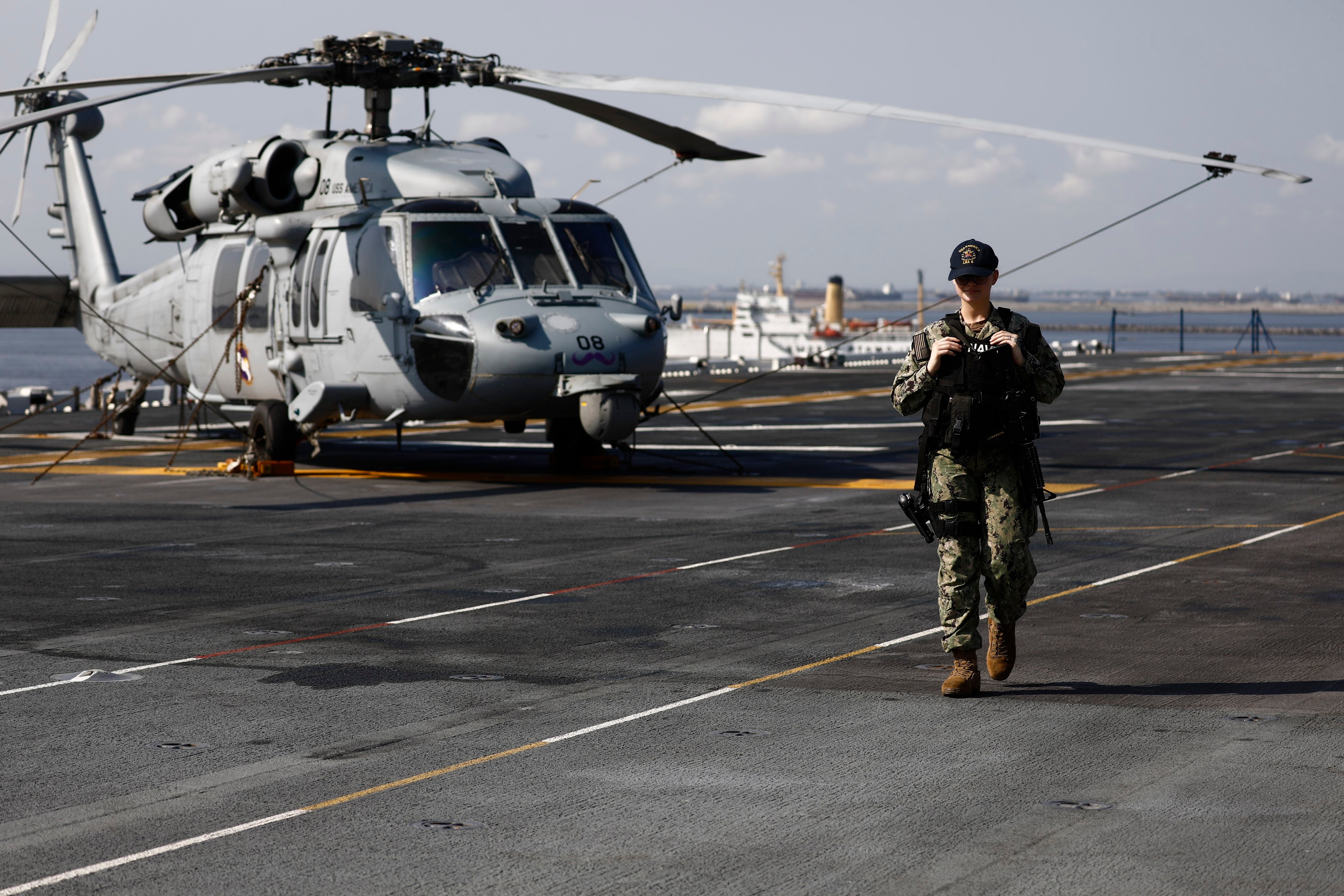 An armed US navy sailor conducts patrol on the deck of the USS America (LH-6) amphibious assault ship docked at Port of Manila, in Manila, Philippines in March 2023. Photo: EPA-EFE