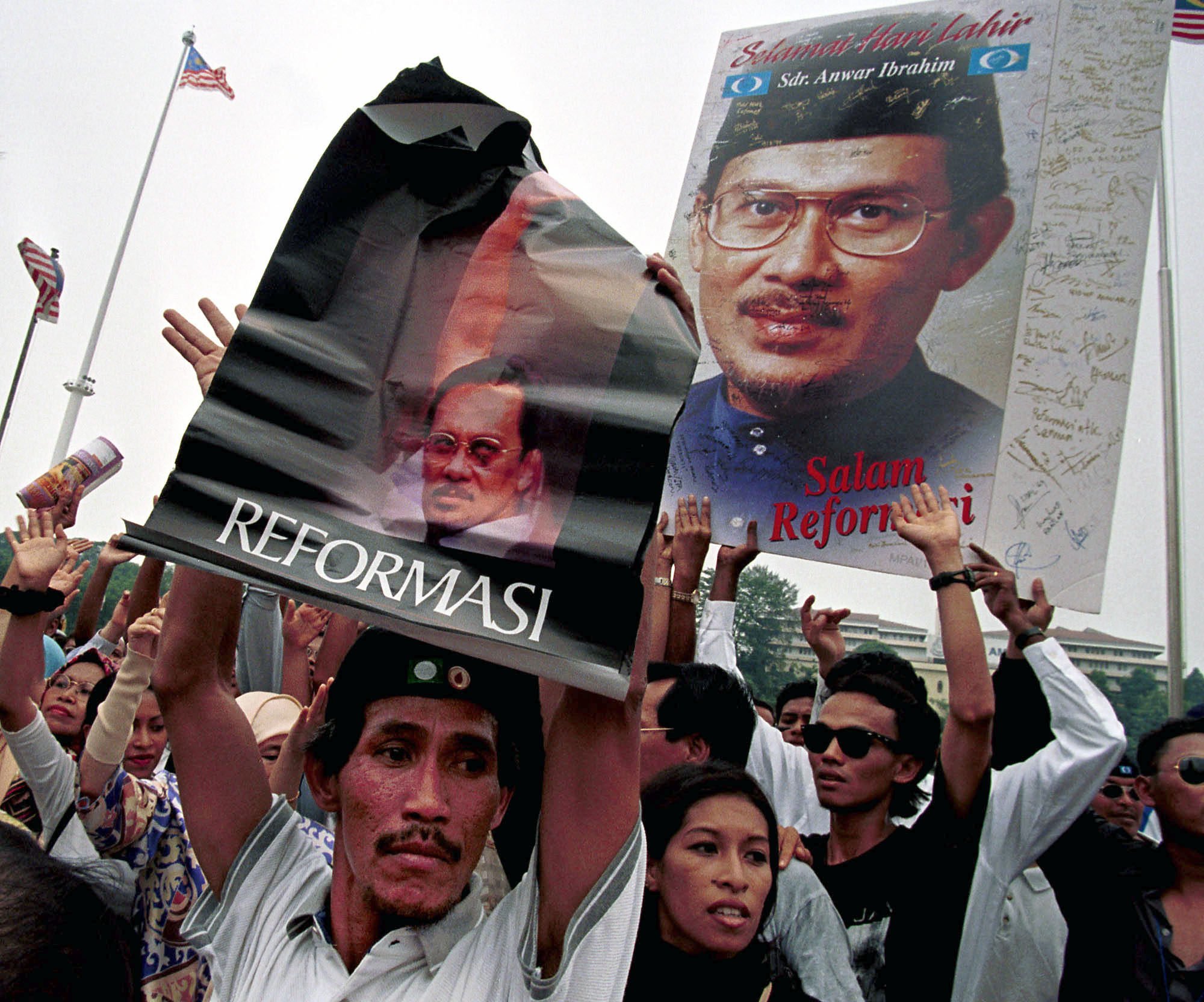 Supporters of Anwar Ibrahim, Malaysia ousted deputy prime minister, hold “Reformasi” posters during a rally in August 1999 in Kuala Lumpur. File photo: AP