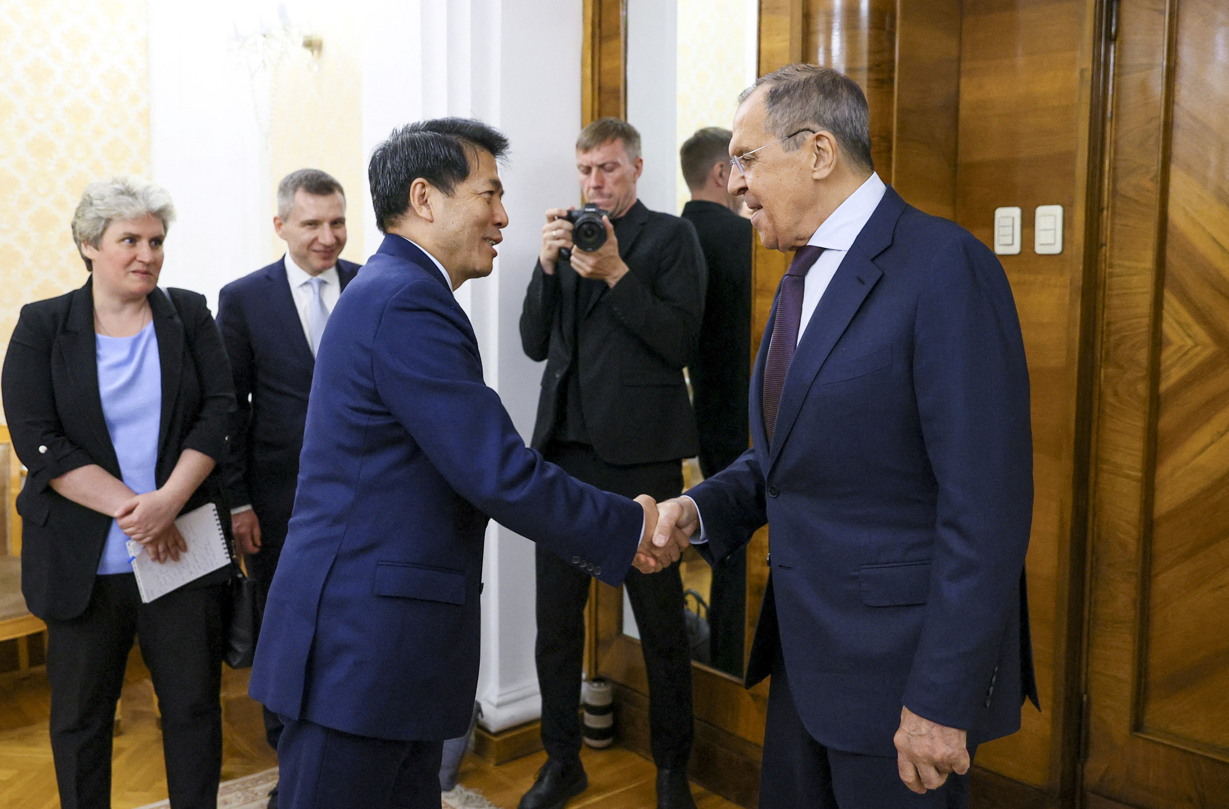 Russian Foreign Minister Sergey Lavrov (right) greets Chinese special envoy for Eurasian affairs Li Hui in Moscow on Friday. Photo: via Reuters