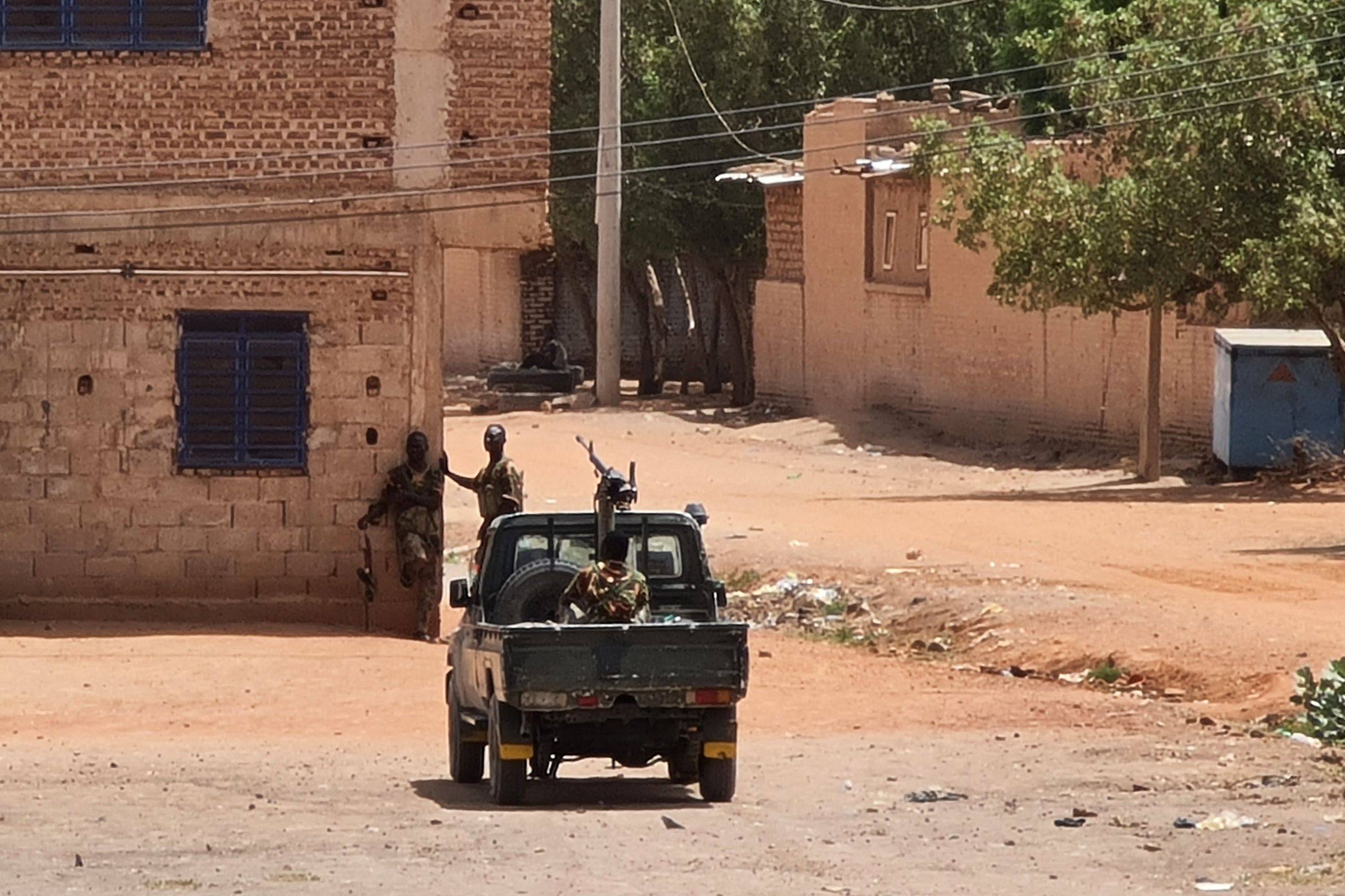 Sudanese army soldiers rest next to a building in Khartoum during  a ceasefire that has allowed beleaguered civilians to venture out, even as they await safe aid corridors and escape routes. Photo: AFP