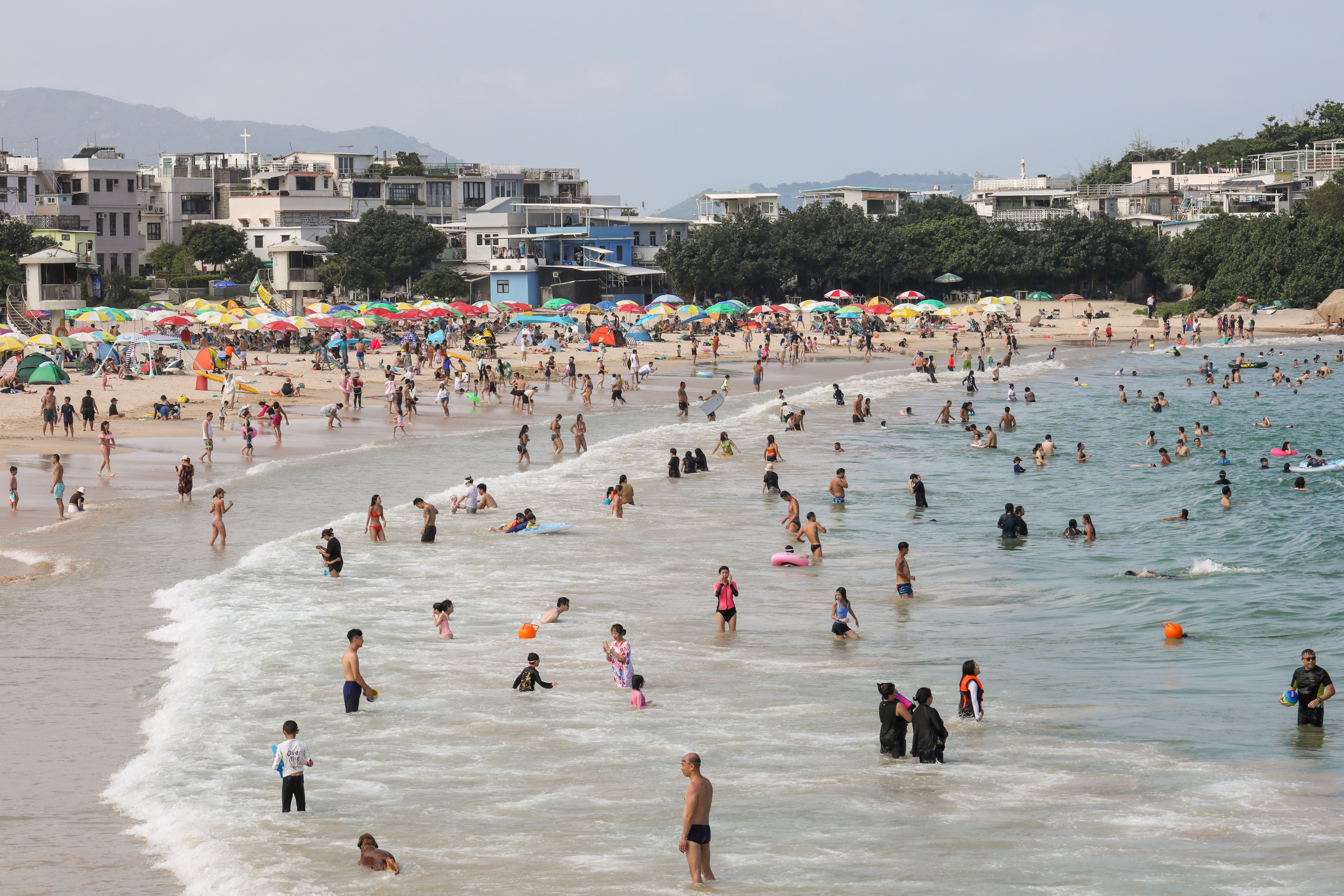 Residents soak up the warm weather on Shek O beach on Sunday. Photo: Xiaomei Chen