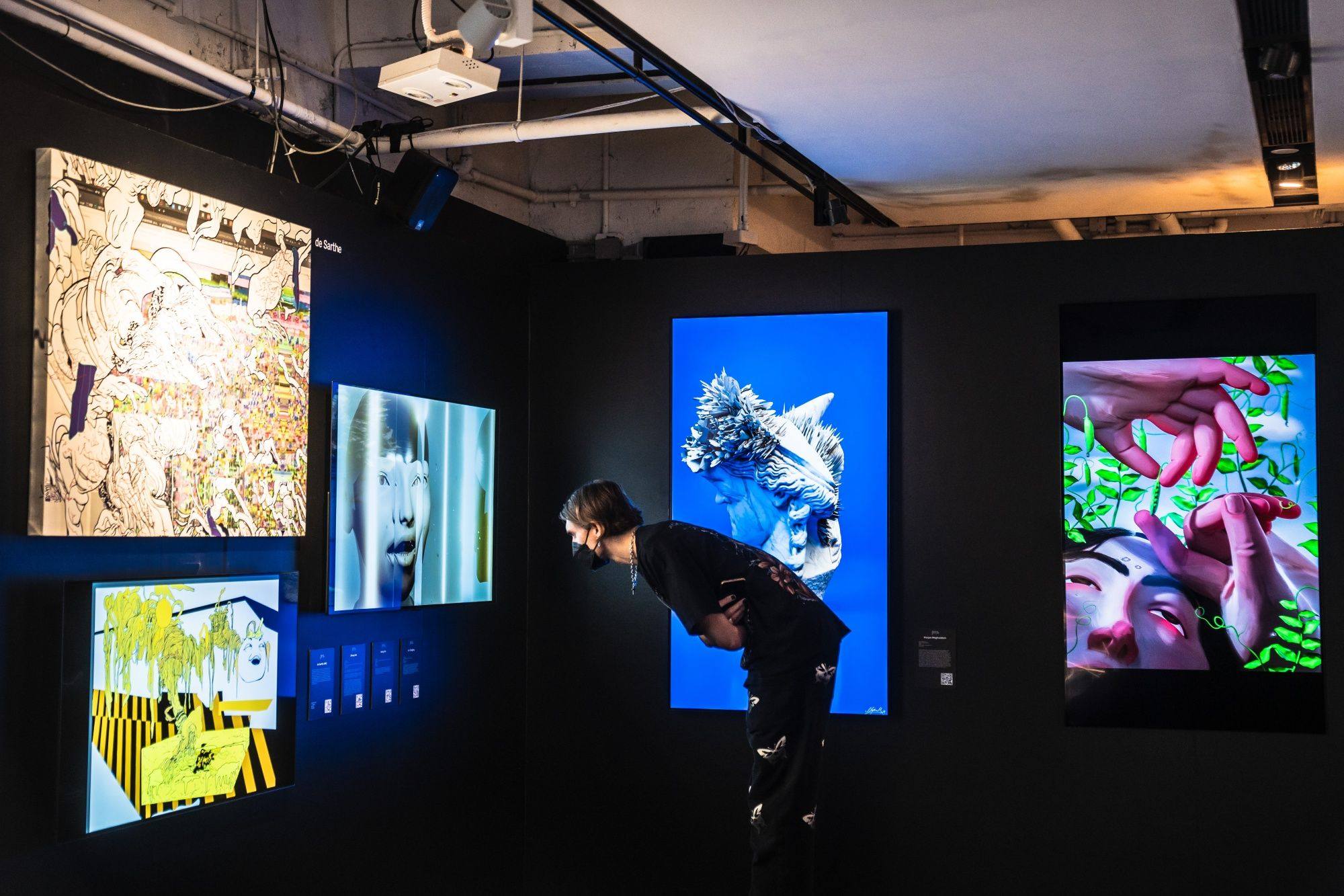 A visitor looks at artwork at the Digital Art Fair in Hong Kong on October 20, 2022. The fair featured digital works by local and international artists and creators, using interactive Web3 technologies, which collectors could purchase as NFTs. Photographer: Lam Yik/Bloomberg