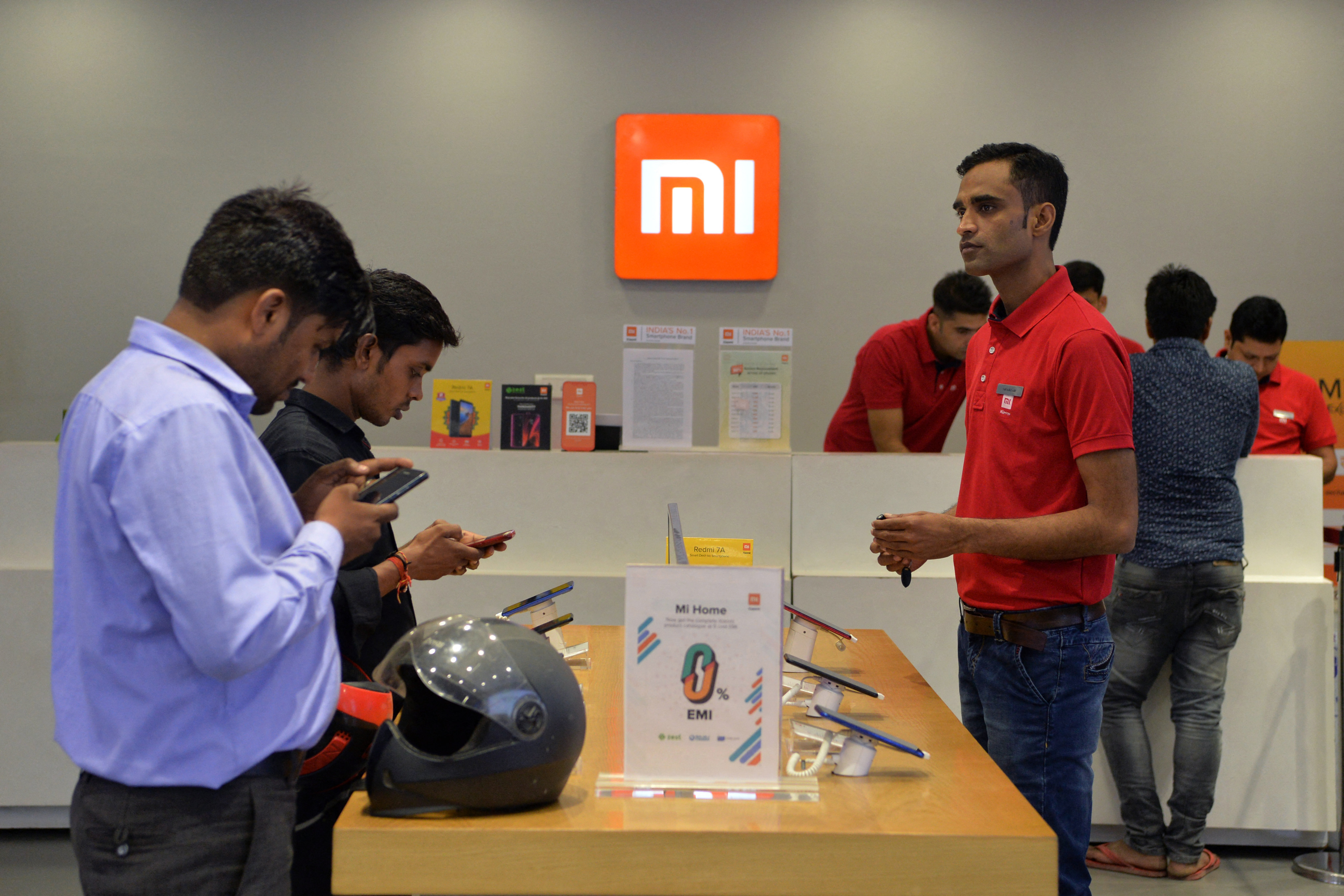 Customers try Xiaomi devices at a Mi store on the outskirts of New Delhi. Photo: AFP
