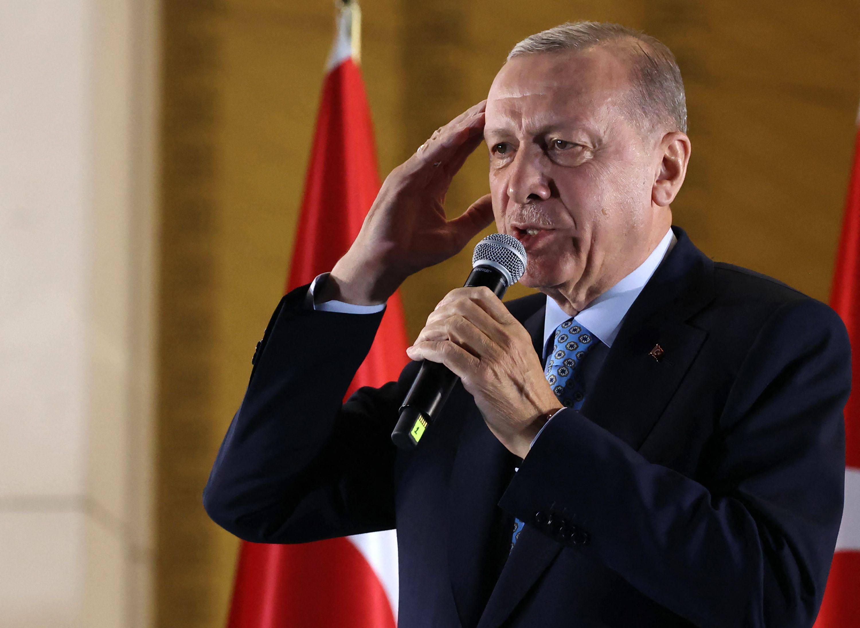 Turkish President Recep Tayyip Erdogan addresses his supporters in Ankara early on Monday after he secured another five years in power. Photo: AFP