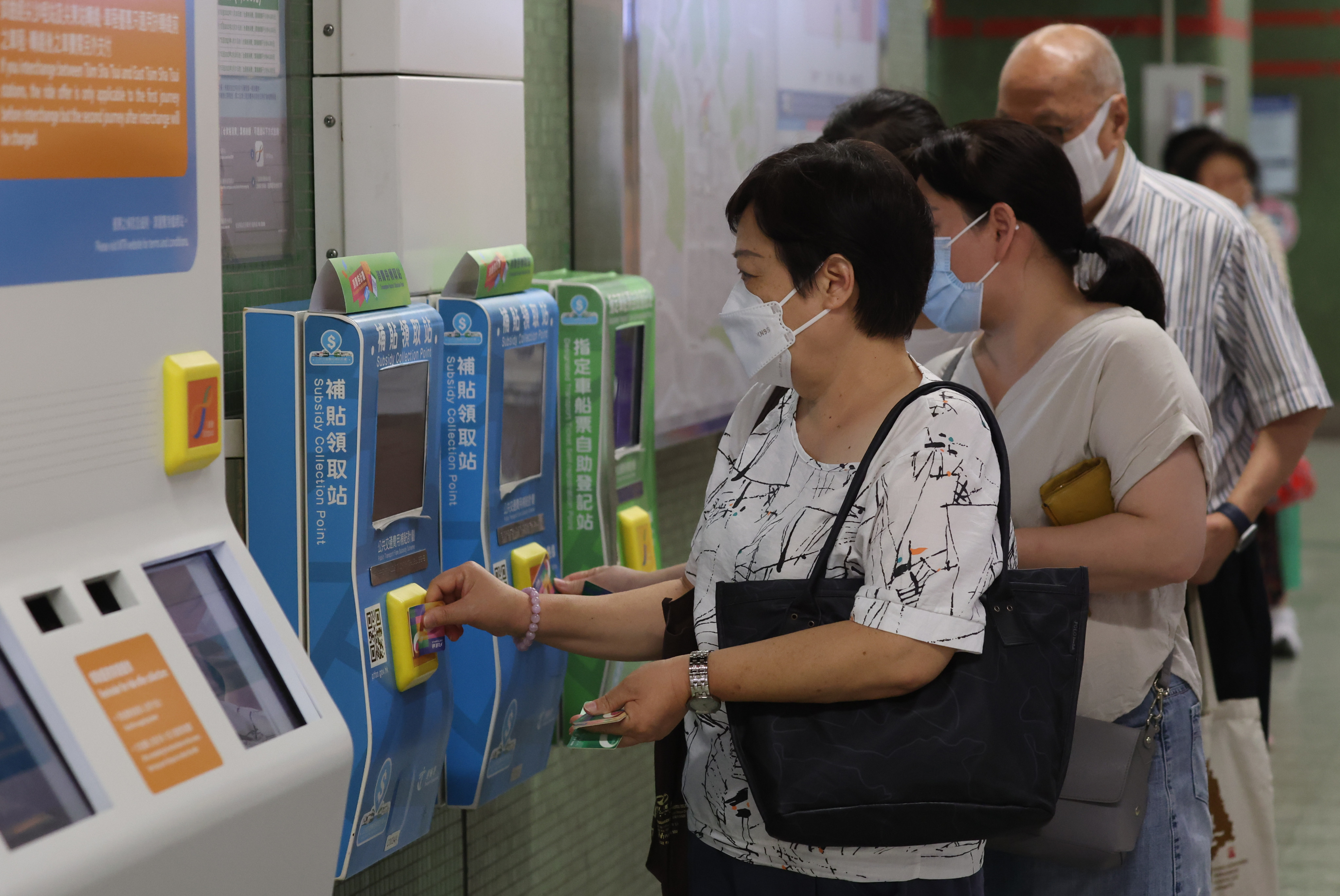 Residents line up to collect their consumption vouchers  at Lok Fu MTR station. Photo: Edmond So