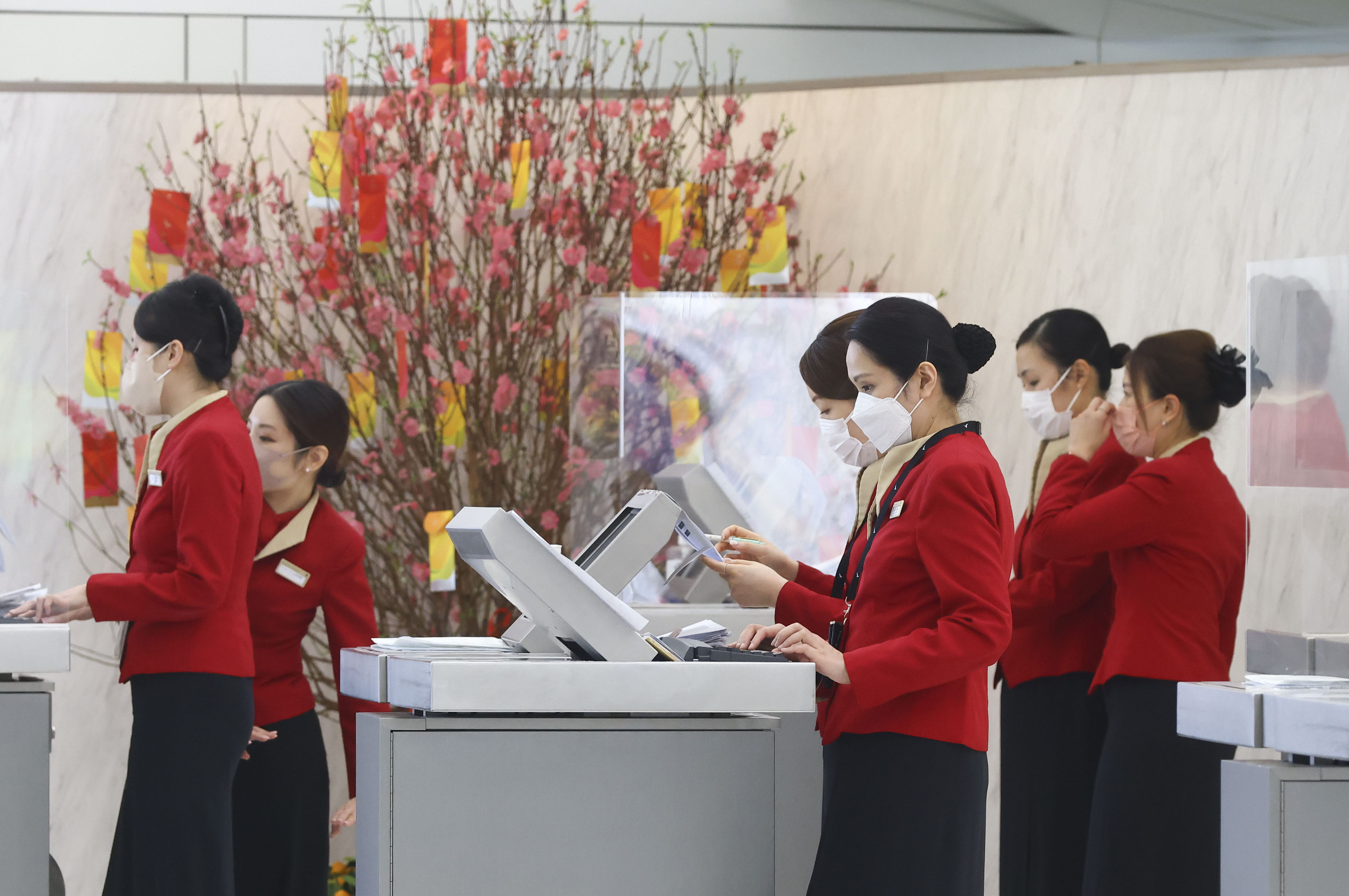 Cathay Pacific staff on duty at Hong Kong airport on January 19, 2023. A recent discrimination scandal saw the airline fire three staff members over insulting comments they made about passengers. Photo: Dickson Lee