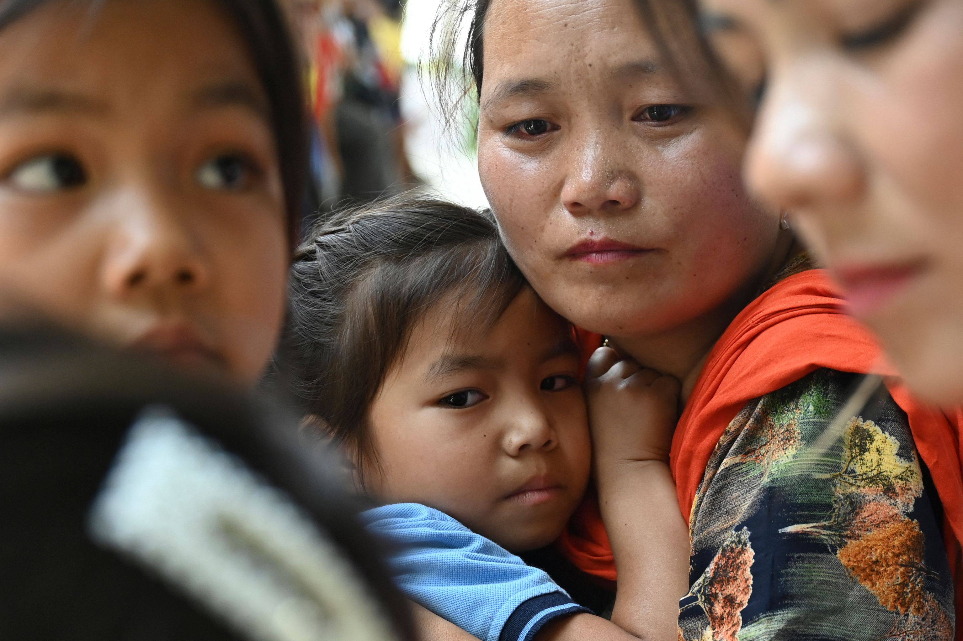 A girl evacuated by the Indian army during ethnic riots in Manipur state embraces her mother after reuniting at a temporary shelter. Photo: AFP