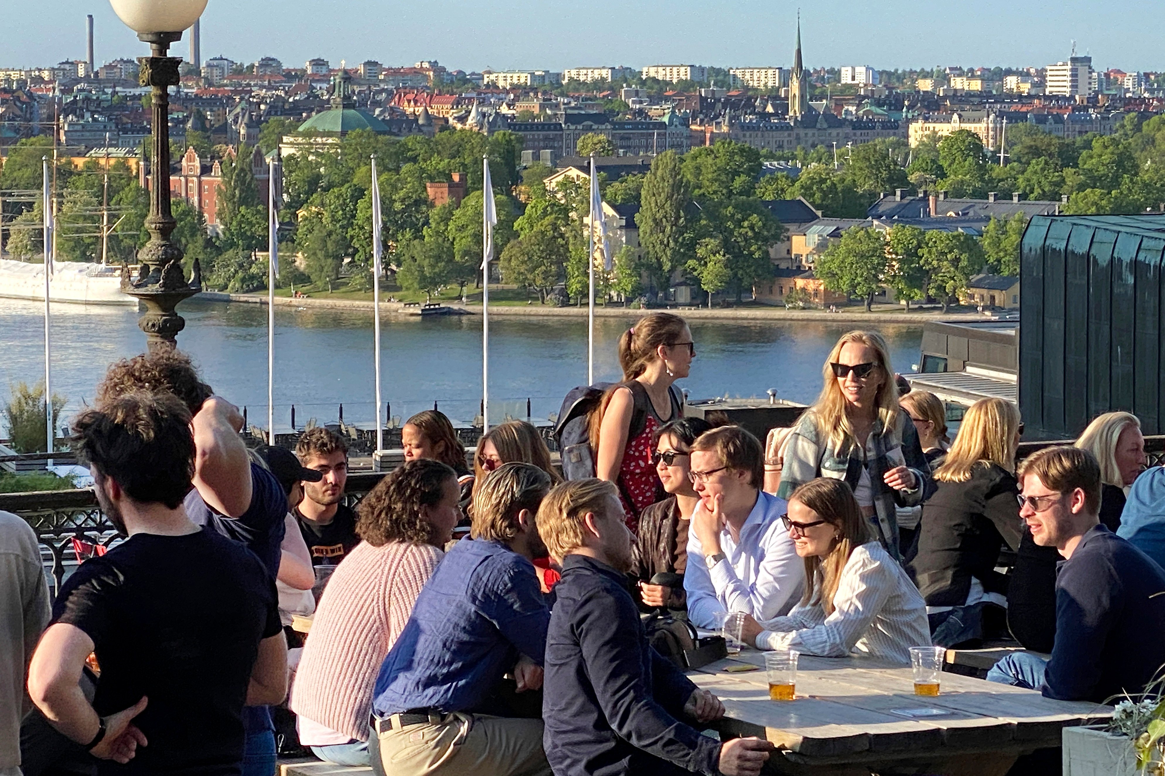 People enjoy drinks and snacks in the evening sun on a terrace overlooking Stockholm. Smoking is prohibited in both indoor and outdoor areas of bars and restaurants in Sweden, which has the lowest share of smokers in the European Union. Photo: AP