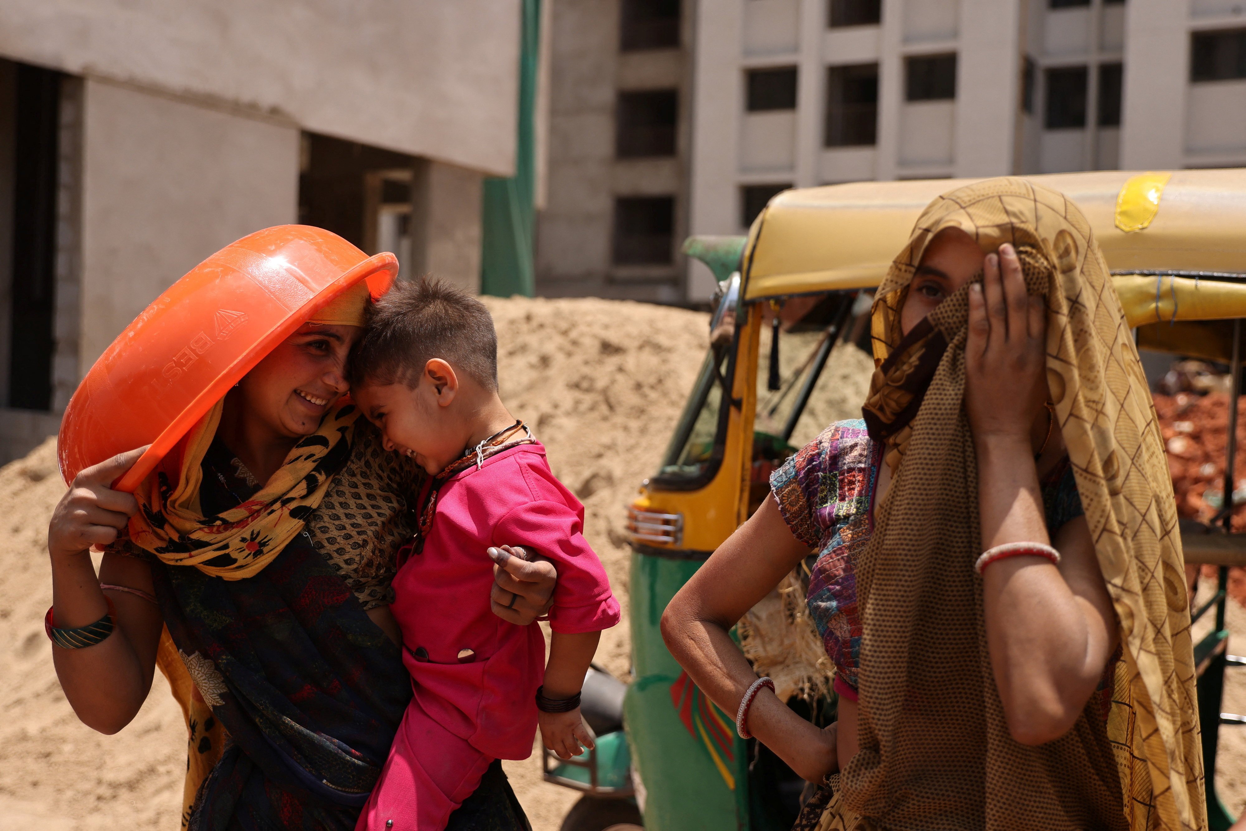 Women take shelter from the sun at a construction site in Ahmedabad, India, on April 28. Photo: Reuters