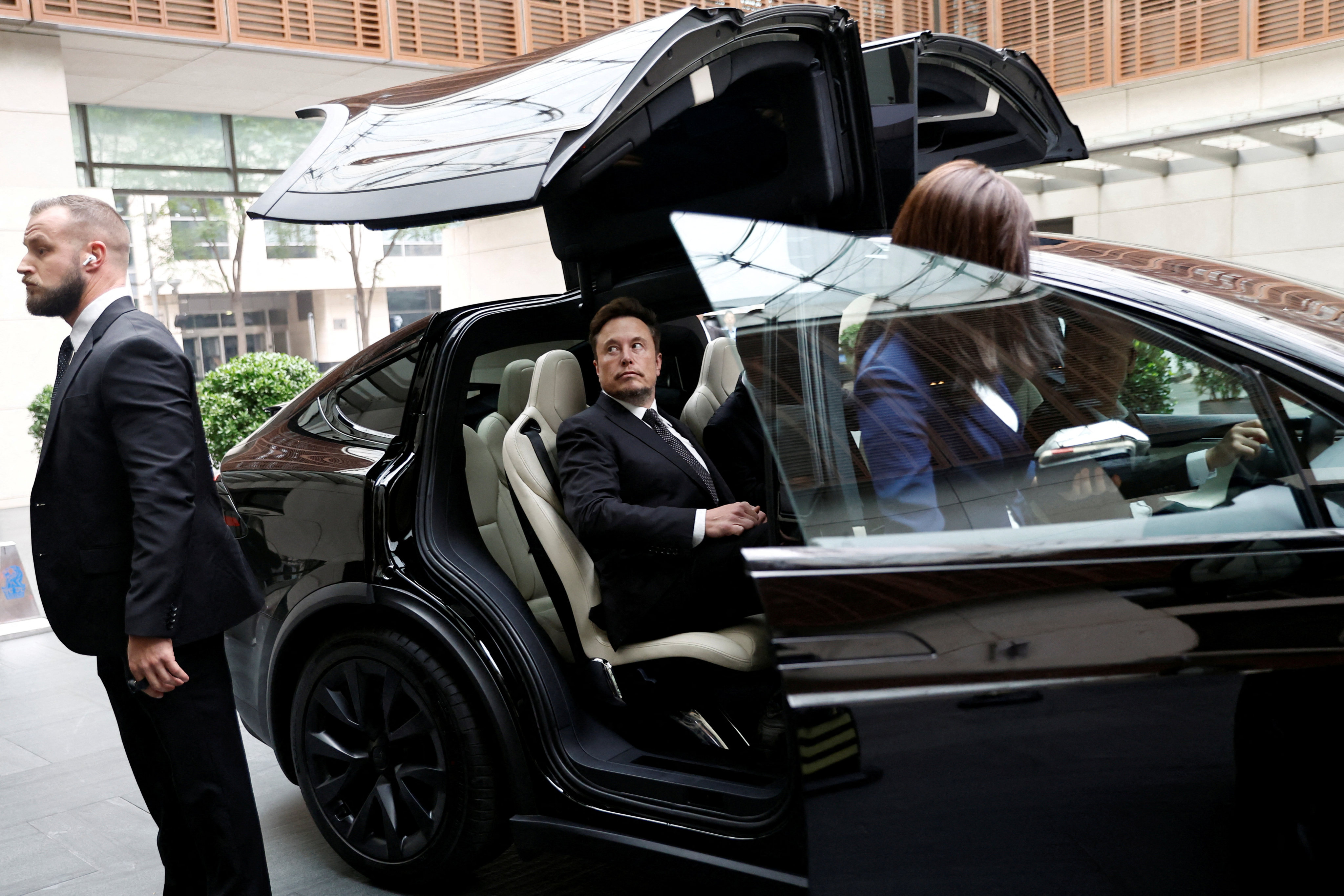 Elon Musk leaves a hotel in Beijing in a Tesla on Wednesday. Photo: Reuters