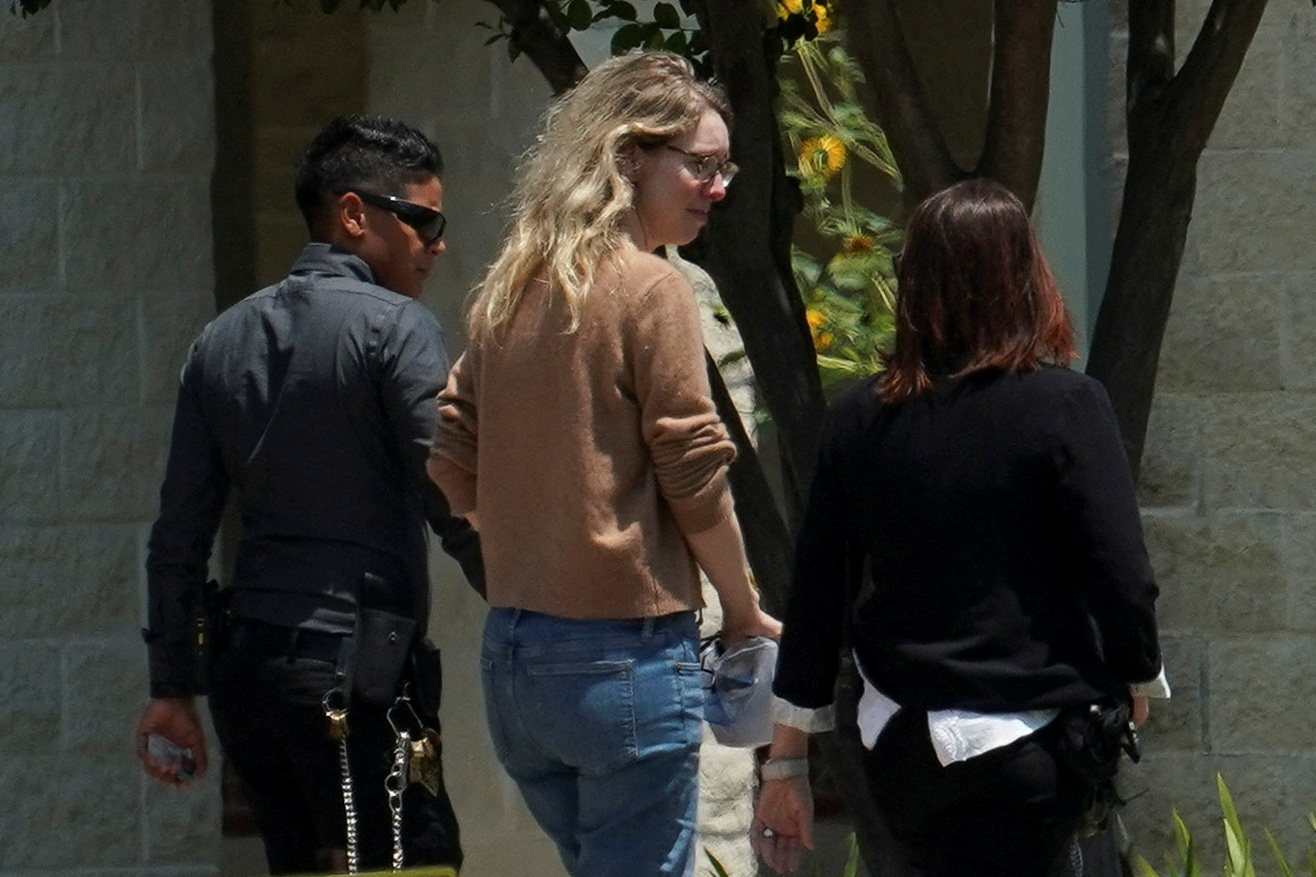 Theranos founder Elizabeth Holmes (centre) arrives at the Federal Prison Camp in Bryan, Texas, on Tuesday to begin serving her prison sentence for defrauding investors. Photo: Reuters