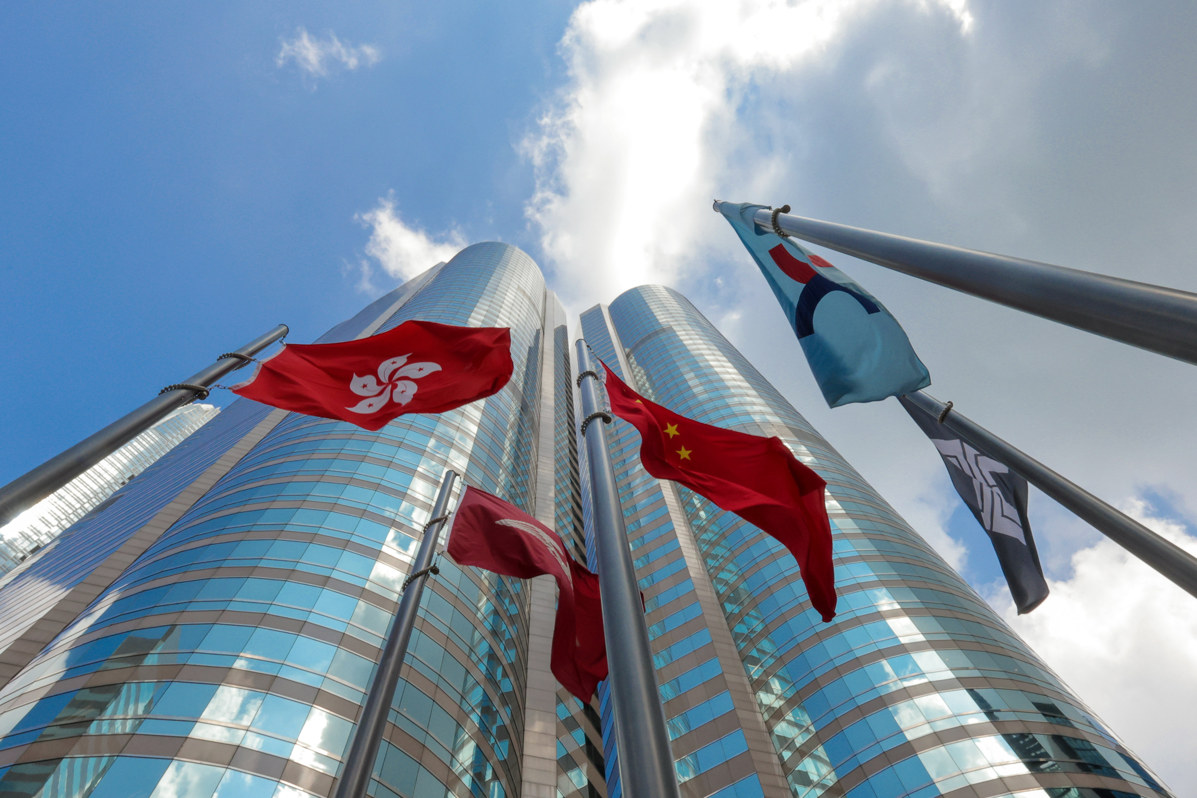 Flags are raised outside the Hong Kong Exchange Square building in Hong Kong, home of the city’s stock exchange. Photo: Jelly Tse