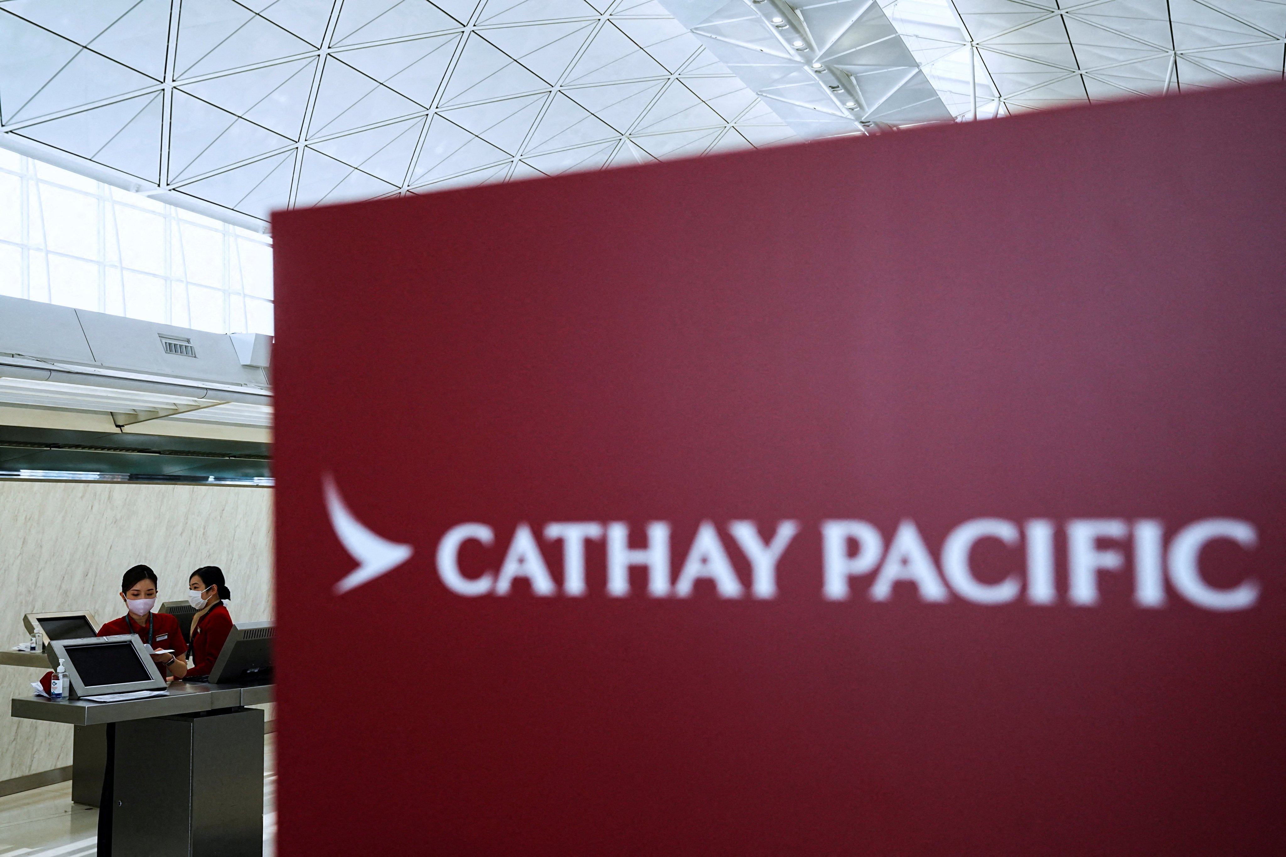 Cathay Pacific employees work at the Hong Kong International Airport on March 8. Hong Kong politicians and the government should make it clear that discrimination is unacceptable but that the scandal was an isolated case. Photo: Reuters