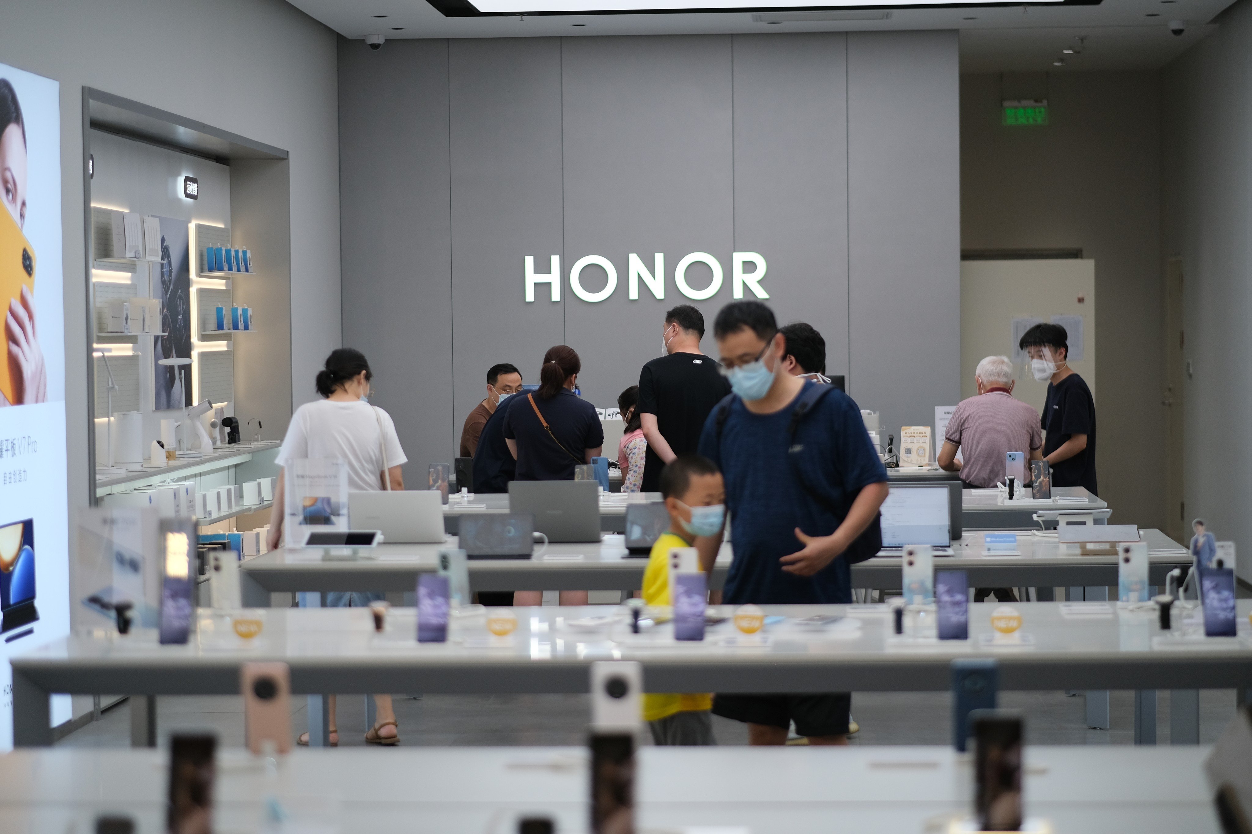 Shoppers seen inside an Honor smartphone retail store in China. Photo: Shutterstock