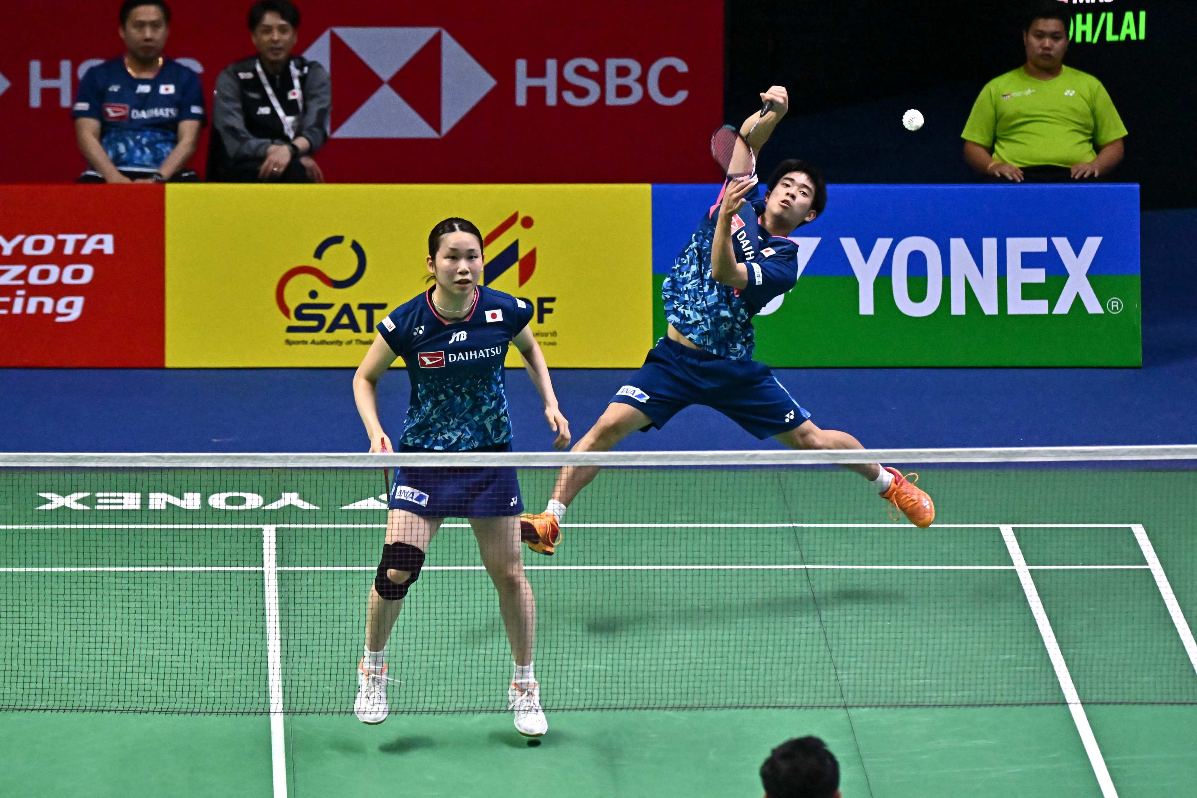 Japan’s Hiroki Midorikawa (right) hits a return as teammate Natsu Saito watches, against Indonesia’s Zacharia Sumanti and Hediana Julimarbela during their mixed doubles match at the 2023 Thailand Open on Wednesday. Photo: AFP