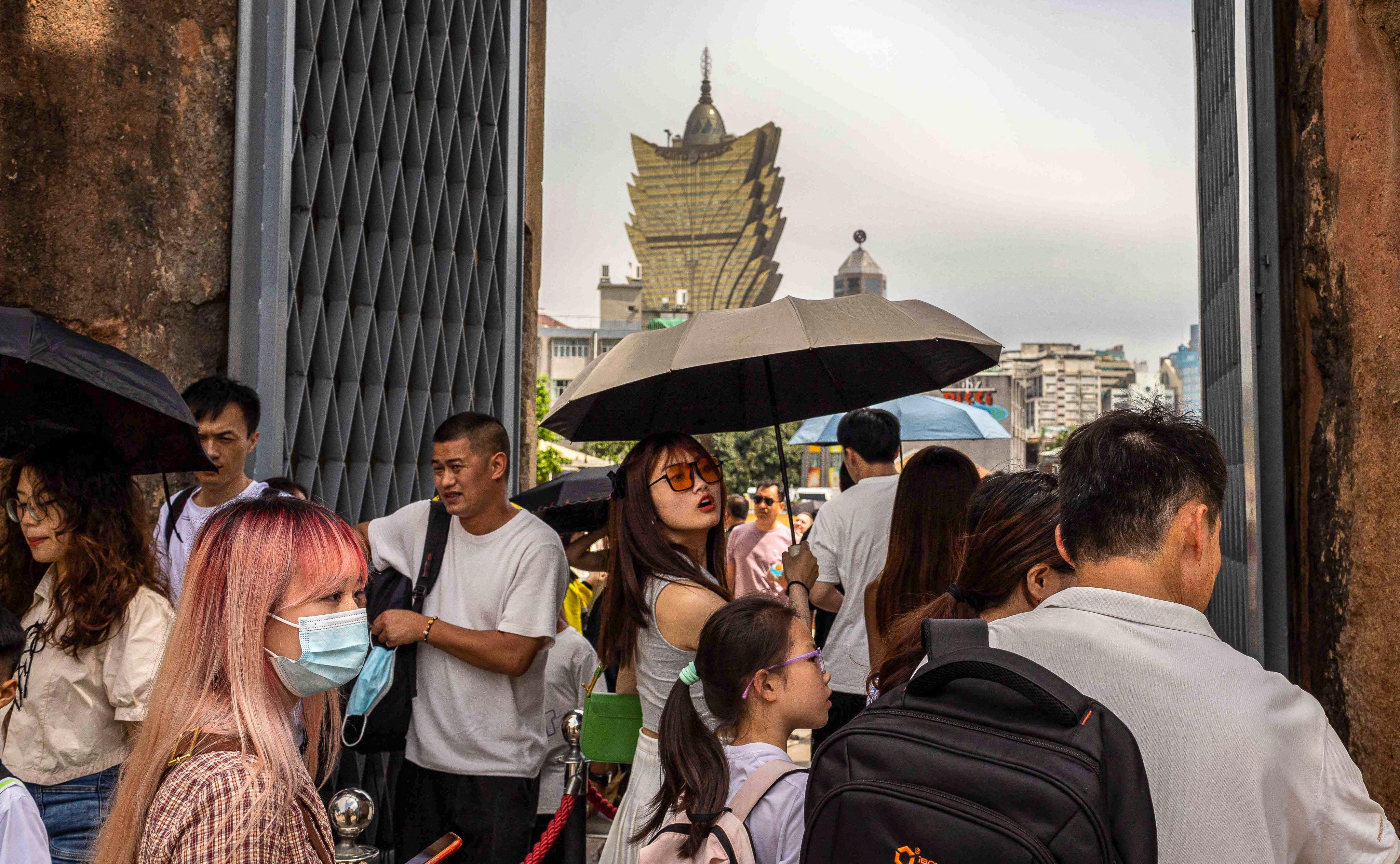 Tourists at the ruins of Saint Paul’s in Macau during the ‘golden week’ holiday in May this year. The latest revenue figures bolster a market consensus that casinos’ earnings are likely to beat expectations this year. Photo: AFP