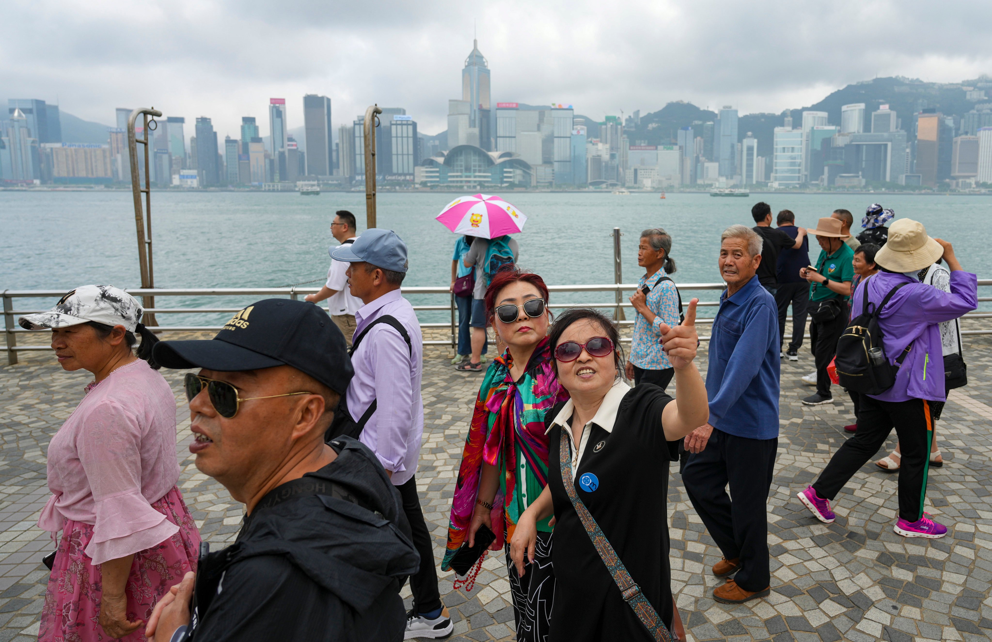 Tourists at Victoria Harbour in Tsim Sha Tsui. Photo: Sam Tsang