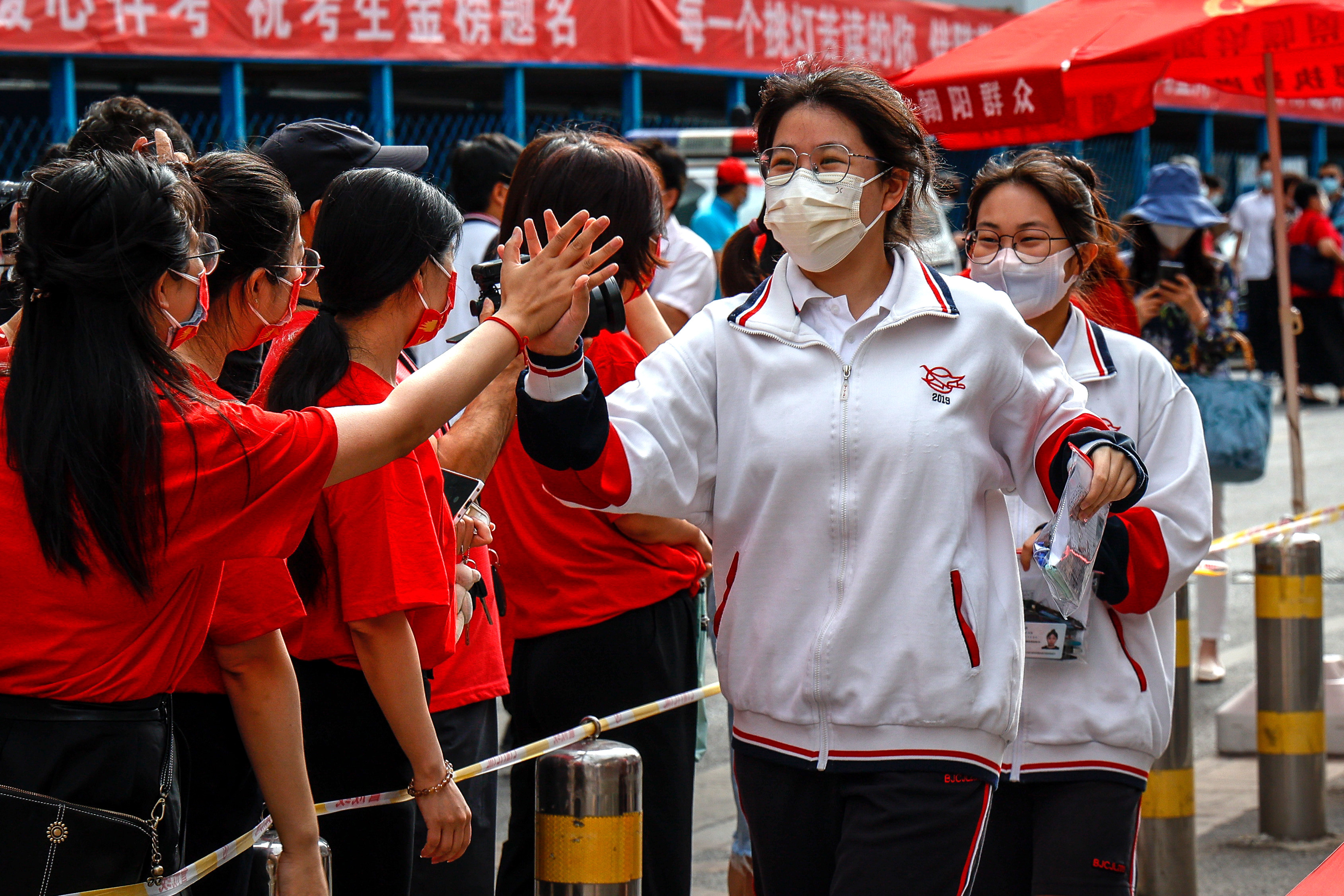 Students are cheered on as they enter a school for China’s annual National College Entrance Examination in Beijing, on June 7, 2022. Some 90 per cent of girls worldwide now receive at least primary school education, compared with 65 per cent in 1970. Photo: EPA-EFE