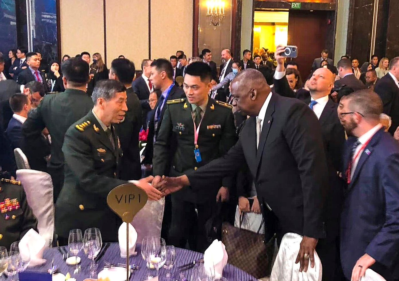 Chinese Defence Minister General Li Shangfu and US Secretary of Defence Lloyd Austin shake hands during the opening dinner for the 20th Shangri-La Dialogue in Singapore on Friday. Photo: Weibo