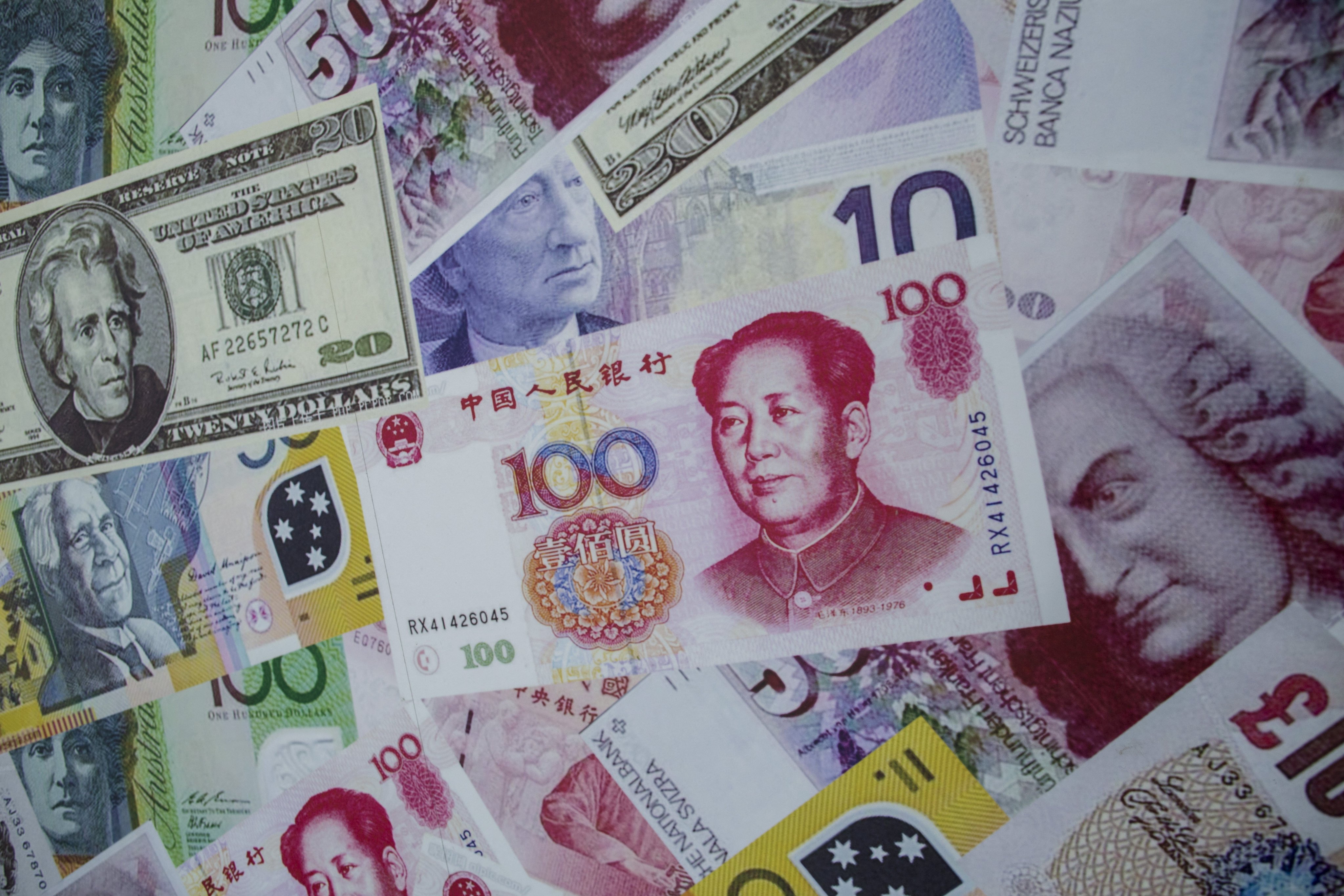 An advertisement poster promoting China’s renminbi (RMB) or yuan , U.S. dollar and Euro exchange services outside a store in Hong Kong. Photo: Reuters