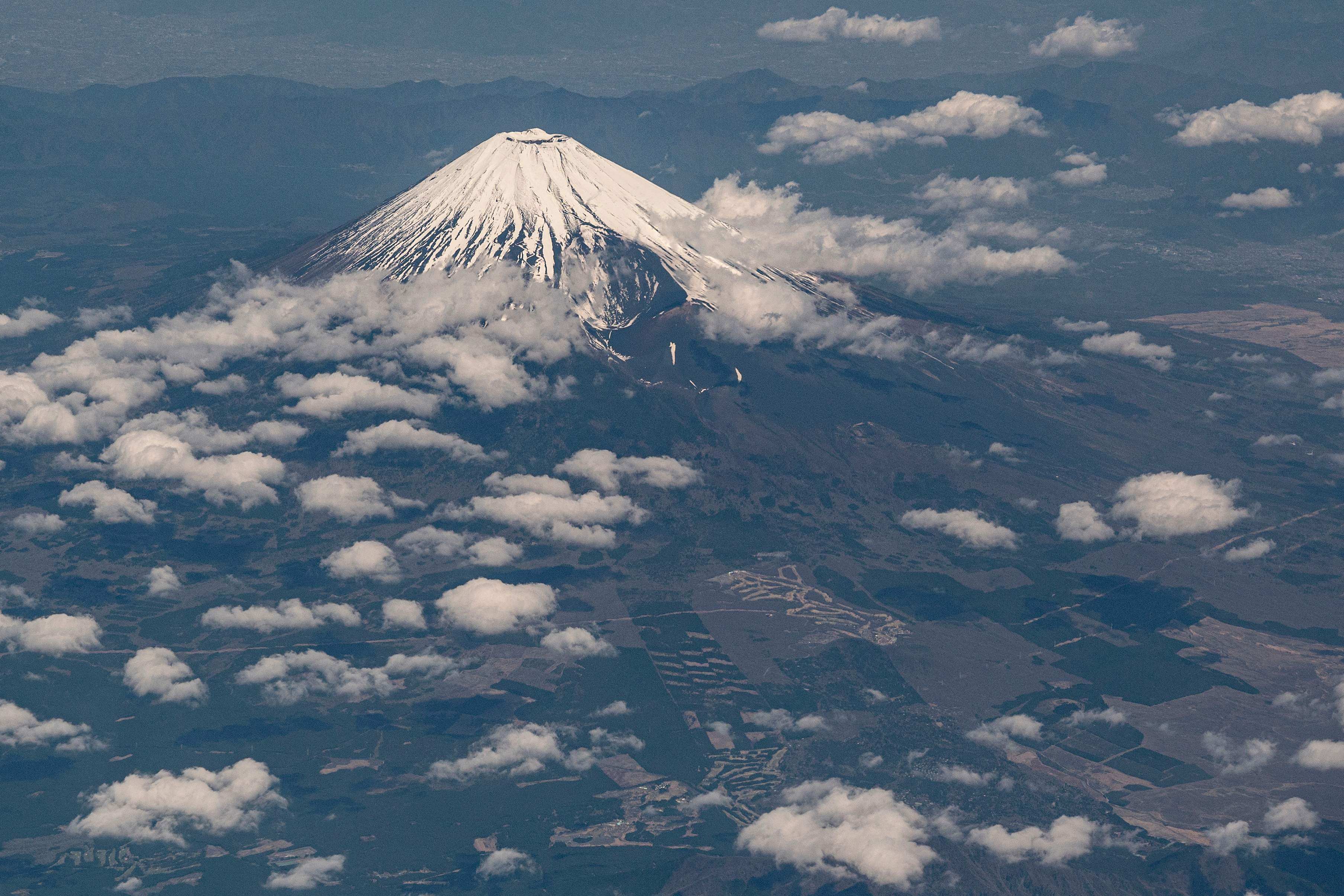 An aerial view of Mount Fuji, Japan’s highest mountain at 3,776 metres, from the window of a passenger jet on April 13, 2023. Photo: AFP