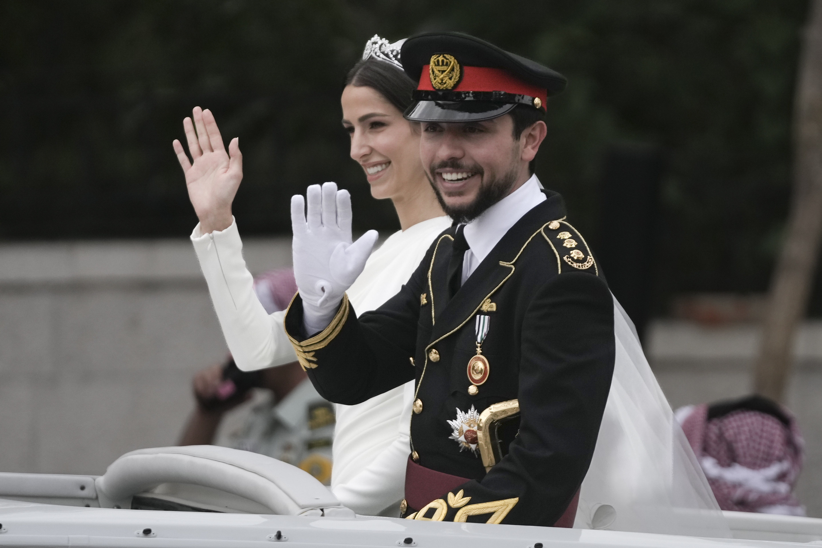 Jordan’s Crown Prince Hussein and Saudi Rajwa Alseif wave to well-wishers during their wedding ceremony in Amman, Jordan on Thursday. Photo: AP