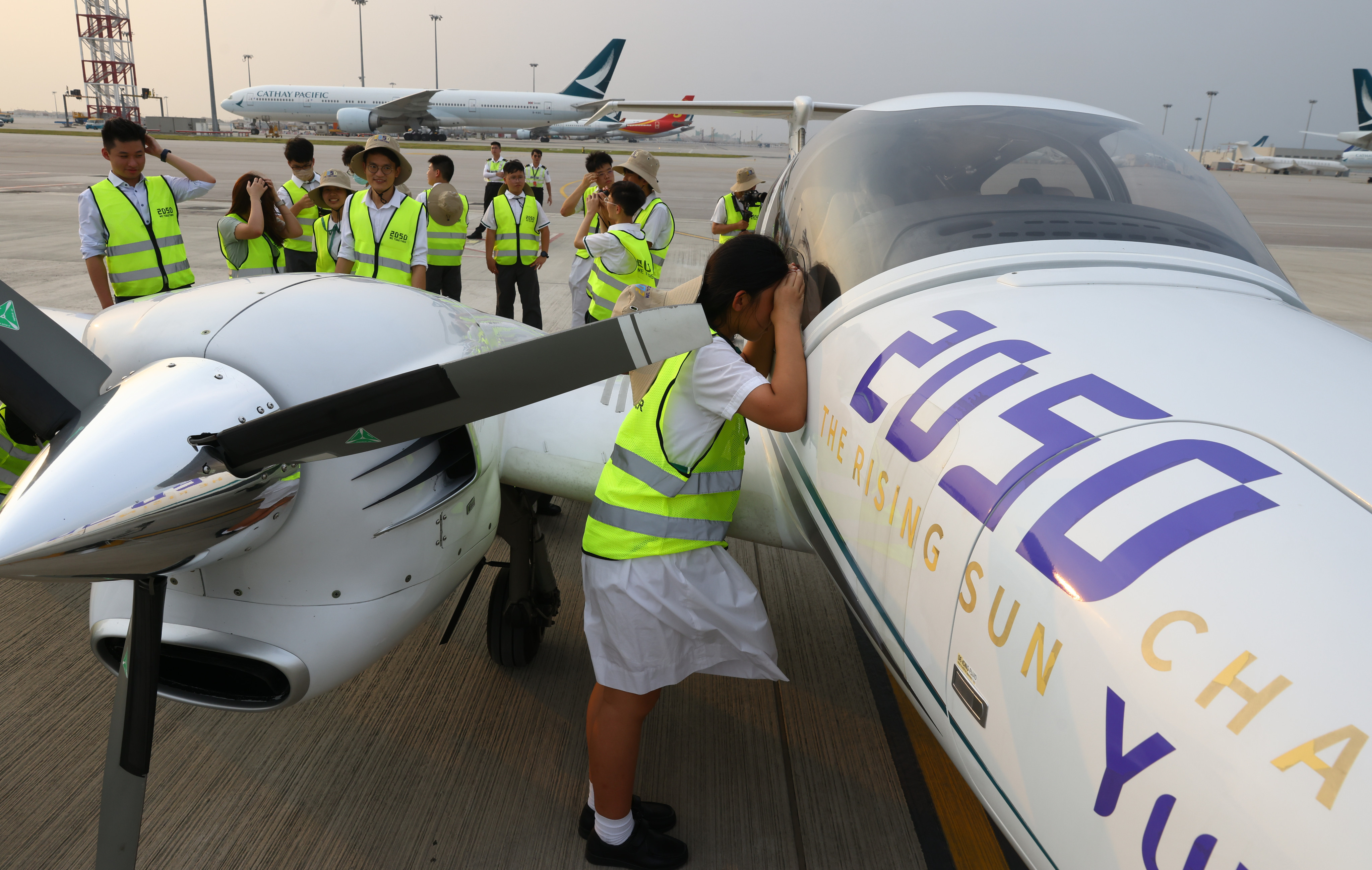 Youngsters from Mu Kuang English School get the chance to examine a Diamond DA42, twin-engined propeller plane, which is on an intercontinental trip to help publicise the “2050” initiative launched by Alibaba Cloud founder Wang Jian. Photo: Dickson Lee